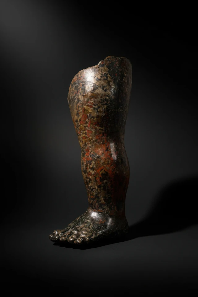 LARGE ROMAN BRONZE LEG FROM A STATUE OF CUPID