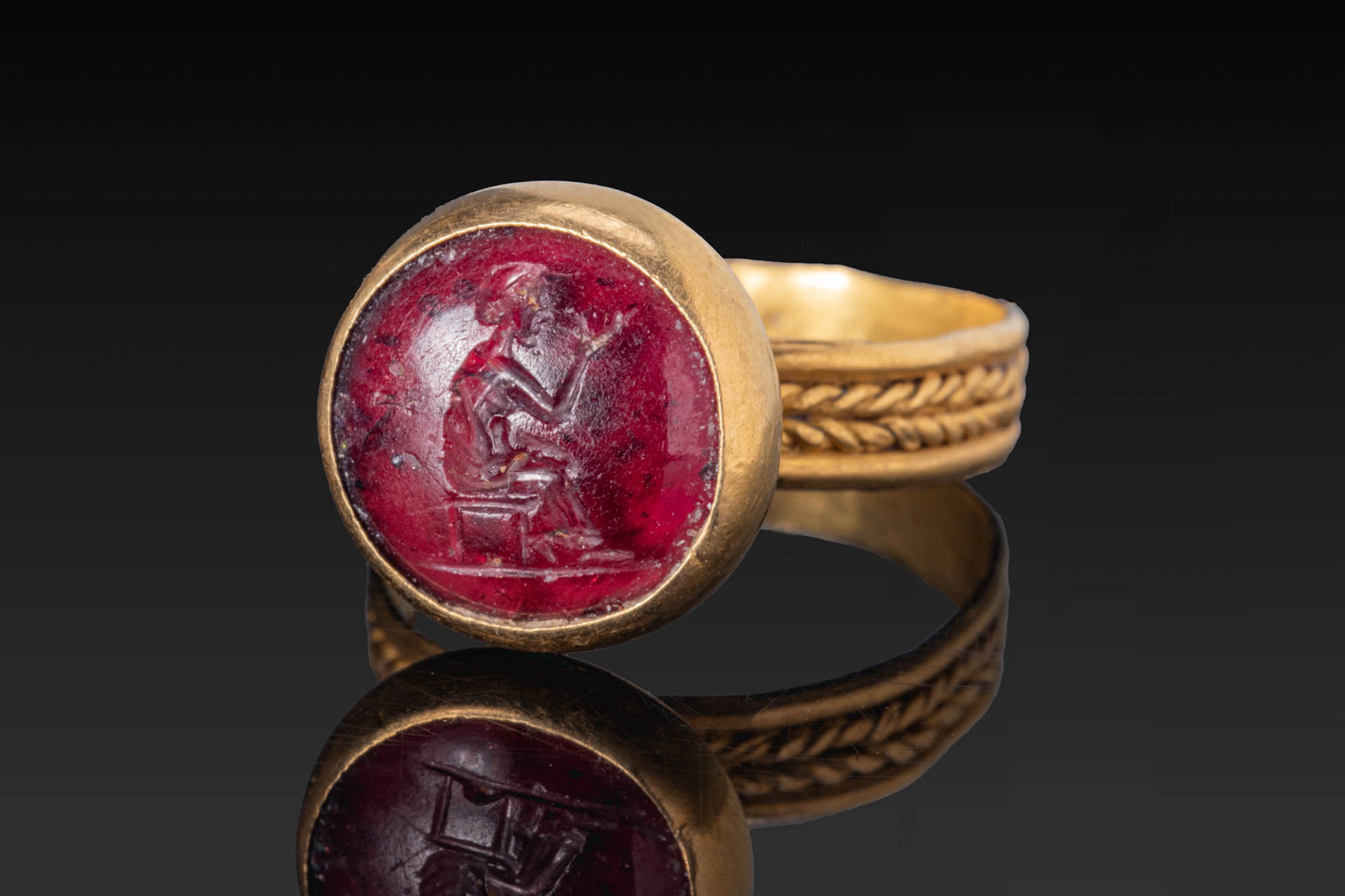 ROMAN RED GARNET INTAGLIO WITH SEATED FIGURE IN GOLD RING