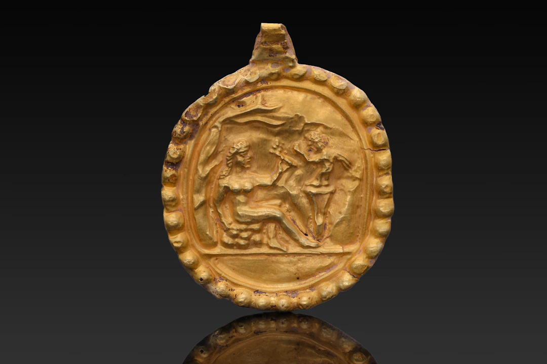 GREEK GOLD MEDALLION WITH APHRODITE AND EROS ON PODIUM