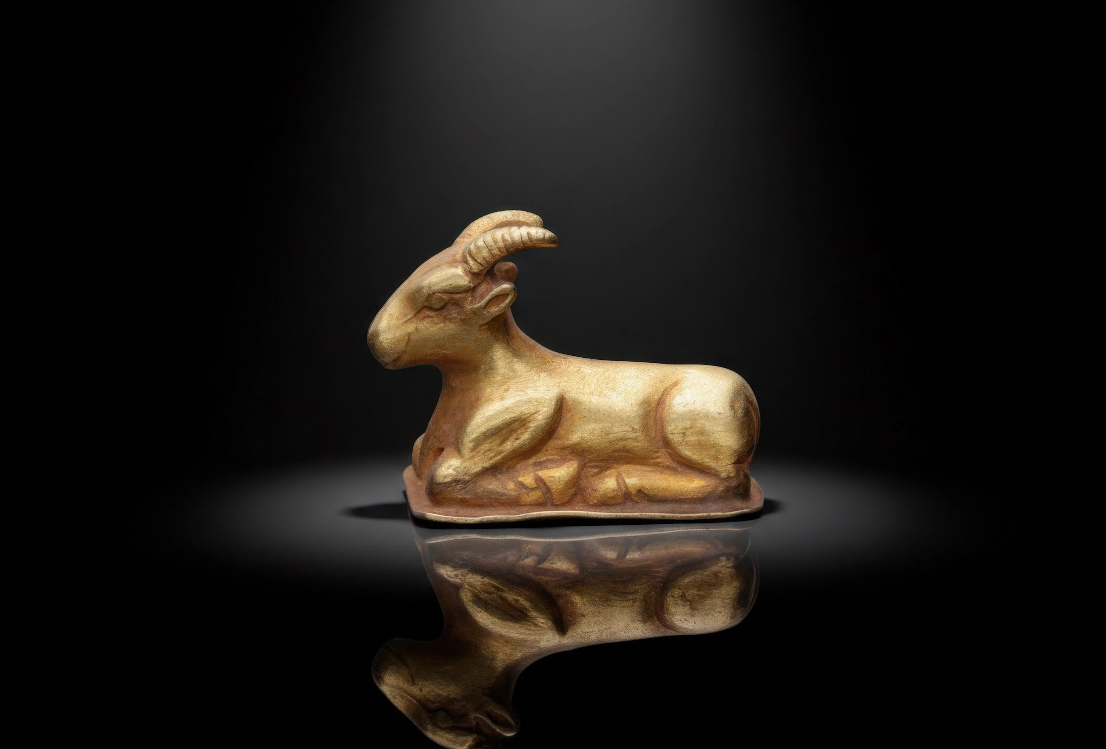 EGYPTIAN GOLD FIGURINE OF RECUMBENT RAM