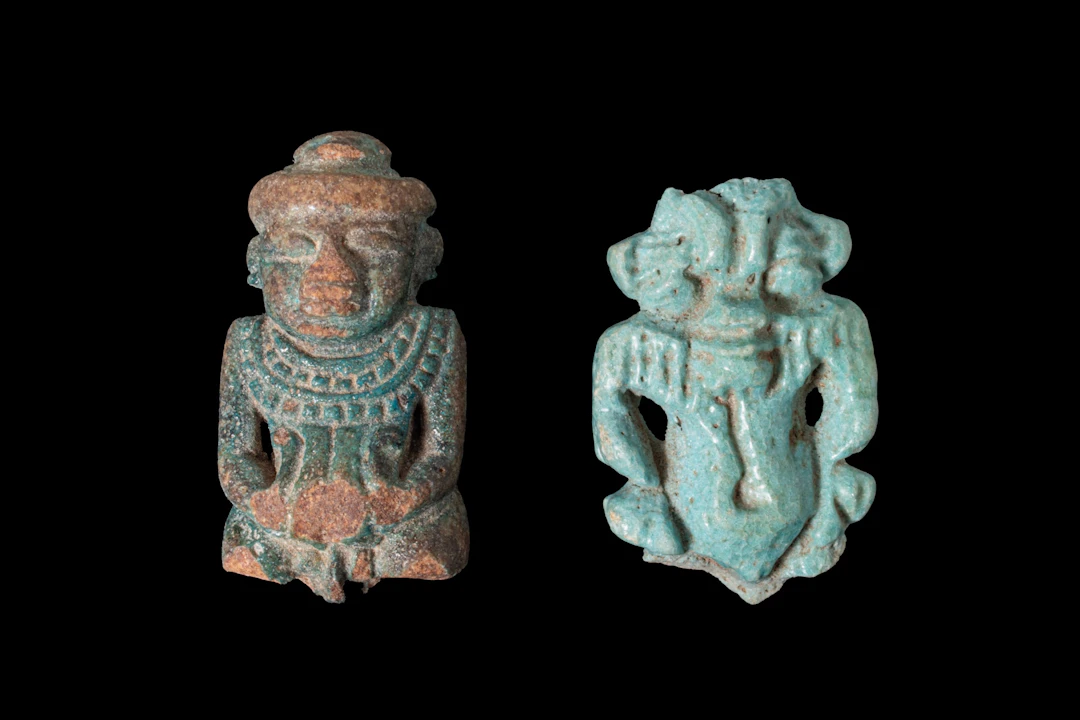 PAIR OF EGYPTIAN FAIENCE AMULETS OF PATAIKOS AND BES