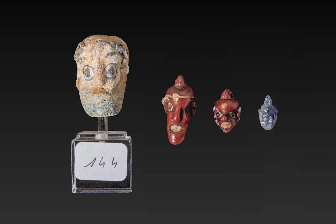 COLLECTION OF CARTHAGINIAN GLASS HEAD BEADS - EX CHRISTIE'S