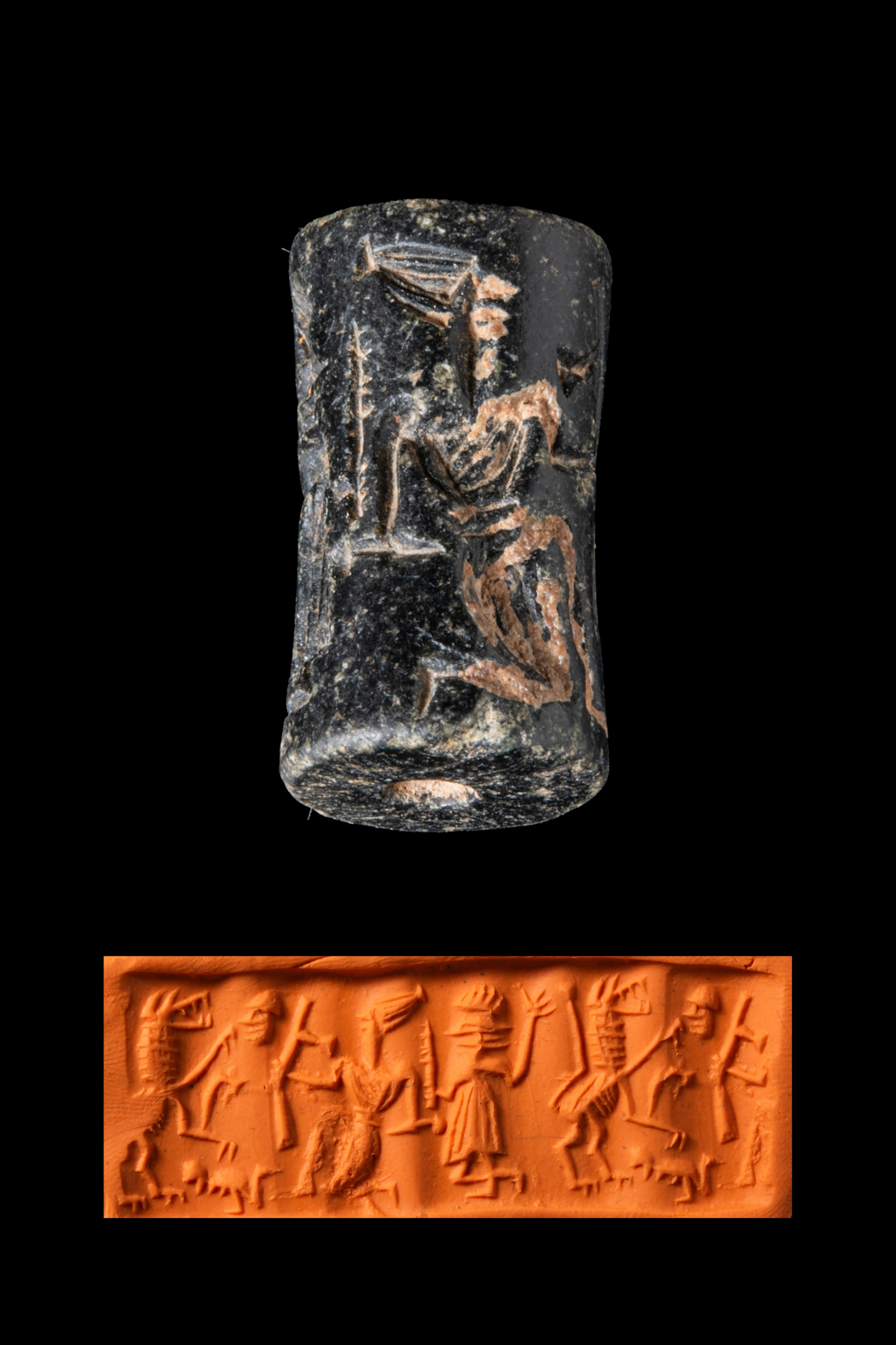 SYRIAN BLACK STONE CYLINDER SEAL WITH FIGURES FIGHTING A LION