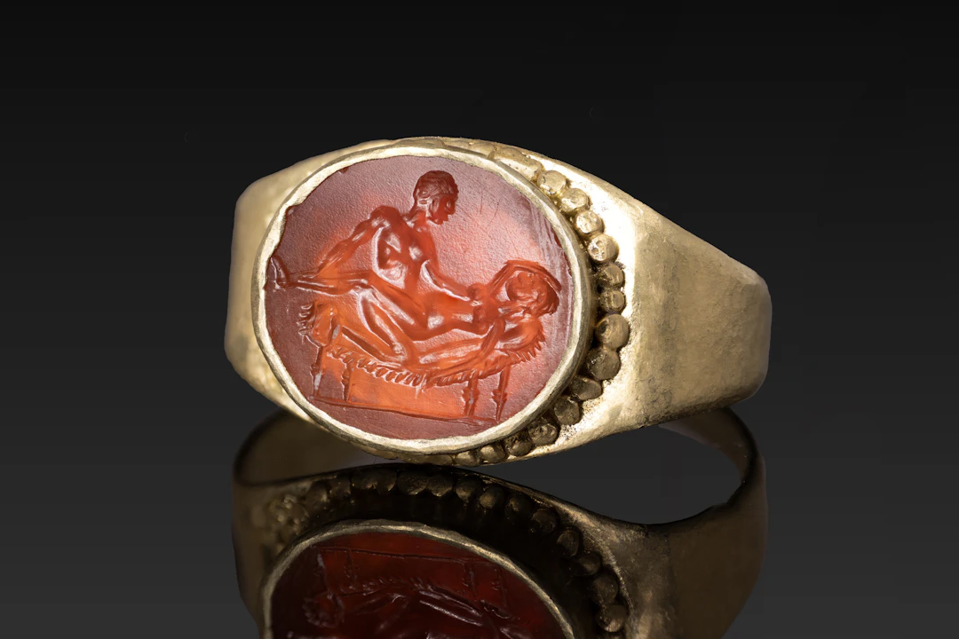ROMAN CARNELIAN INTAGLIO WITH EROTIC SCENE IN GOLD RING