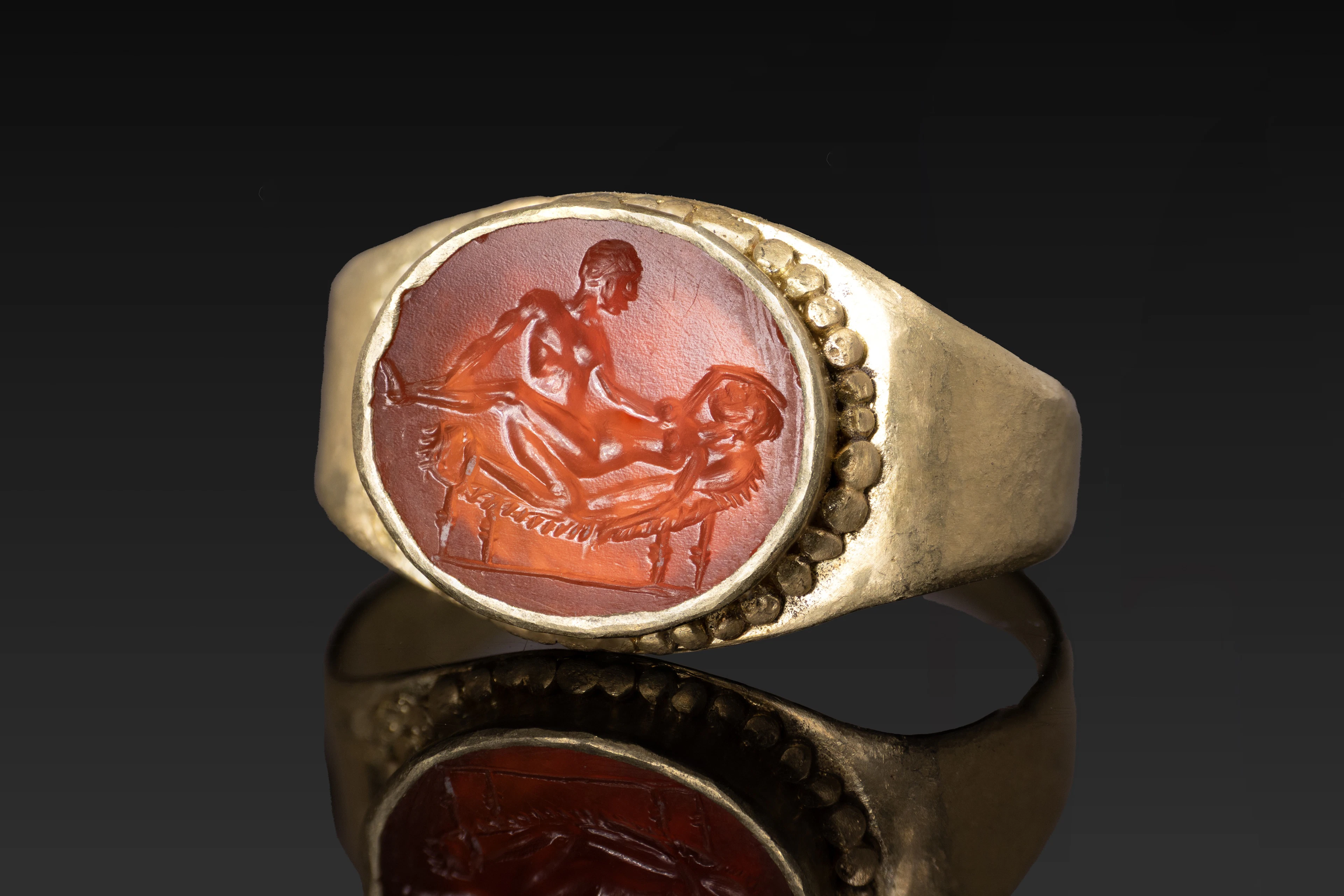 ROMAN CARNELIAN INTAGLIO WITH EROTIC SCENE IN GOLD RING