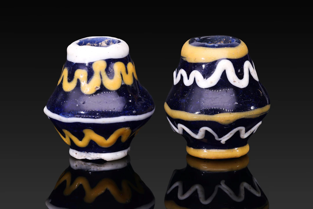 PAIR OF LARGE PHOENICIAN GLASS BEADS WITH ZIGZAG MOTIFS