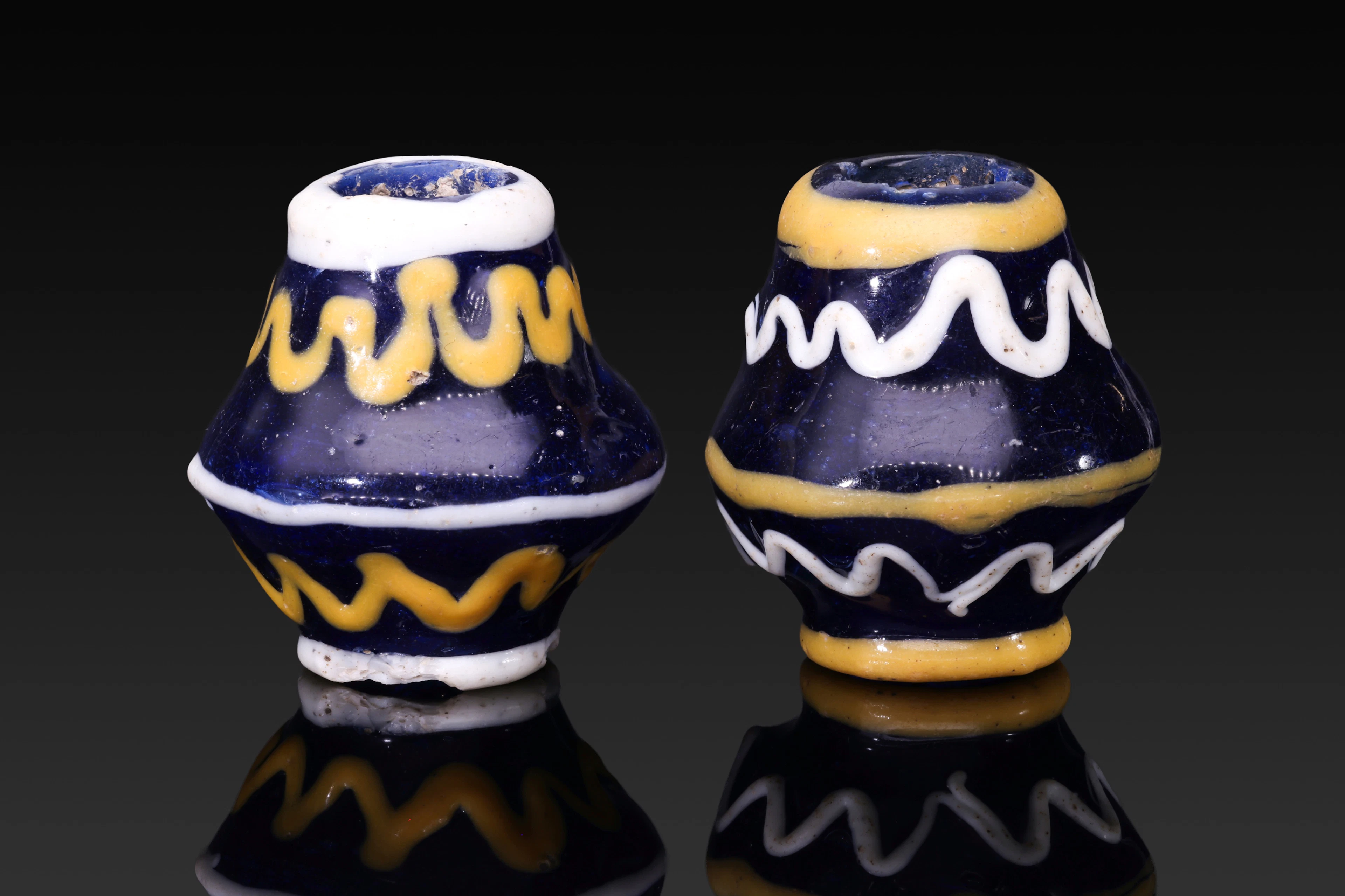PAIR OF LARGE PHOENICIAN GLASS BEADS WITH ZIGZAG MOTIFS