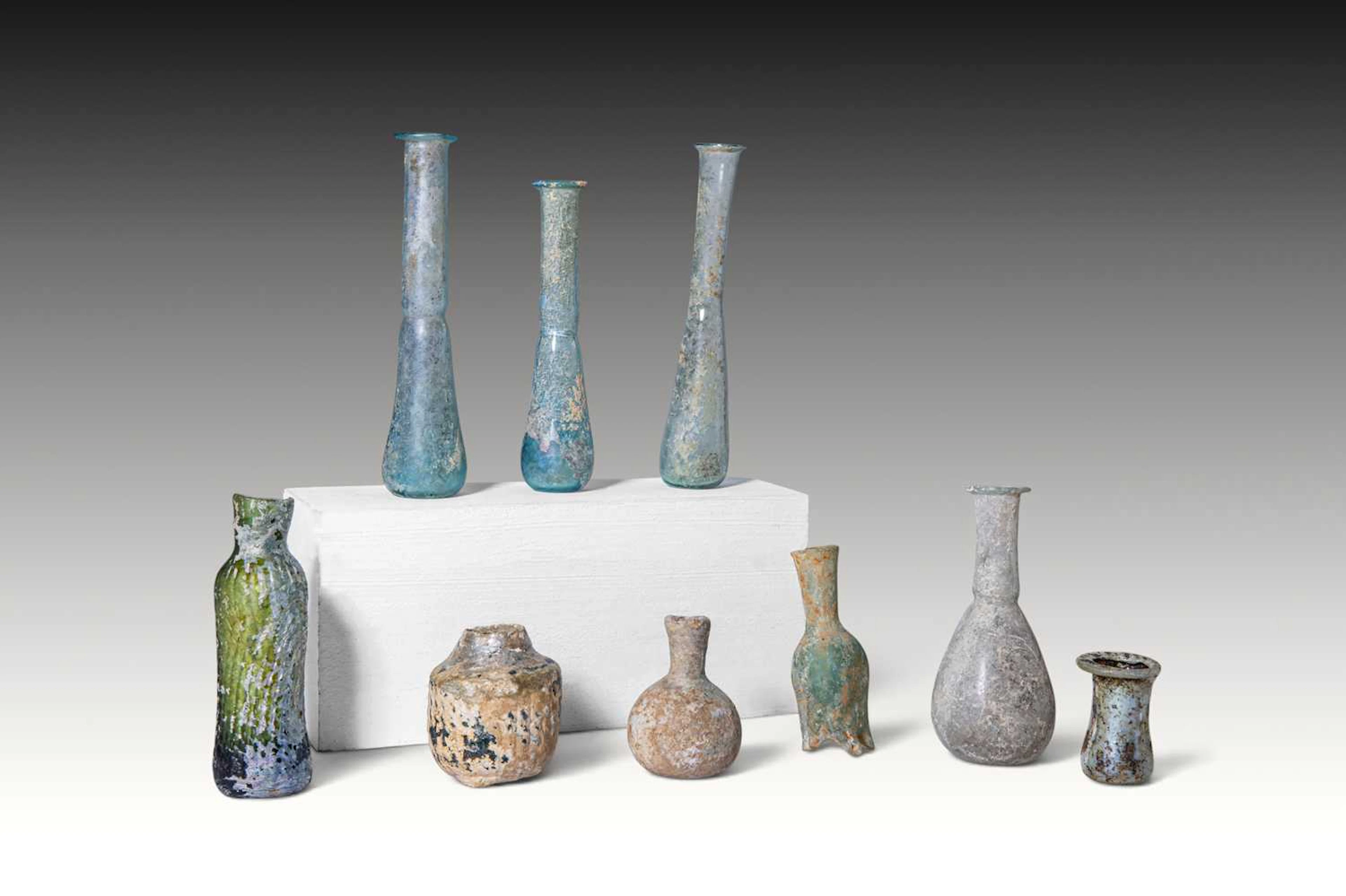 COLLECTION OF NINE ROMAN AND LATE ROMAN GLASS UNGUENTARIA