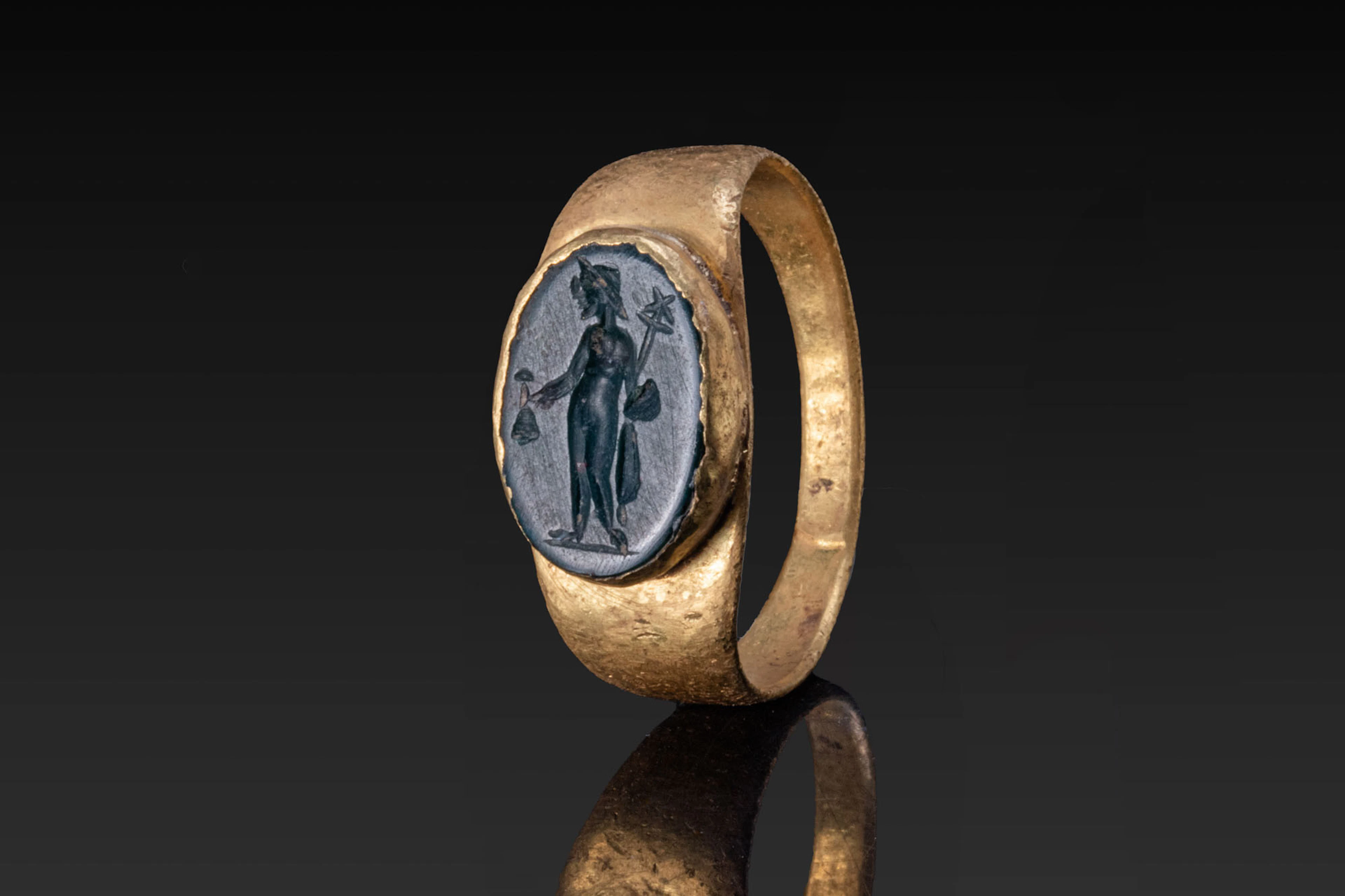 ROMAN GREEN JASPER INTAGLIO DEPICTING MERCURY HOLDING A MONEY BAG IN GOLD RING