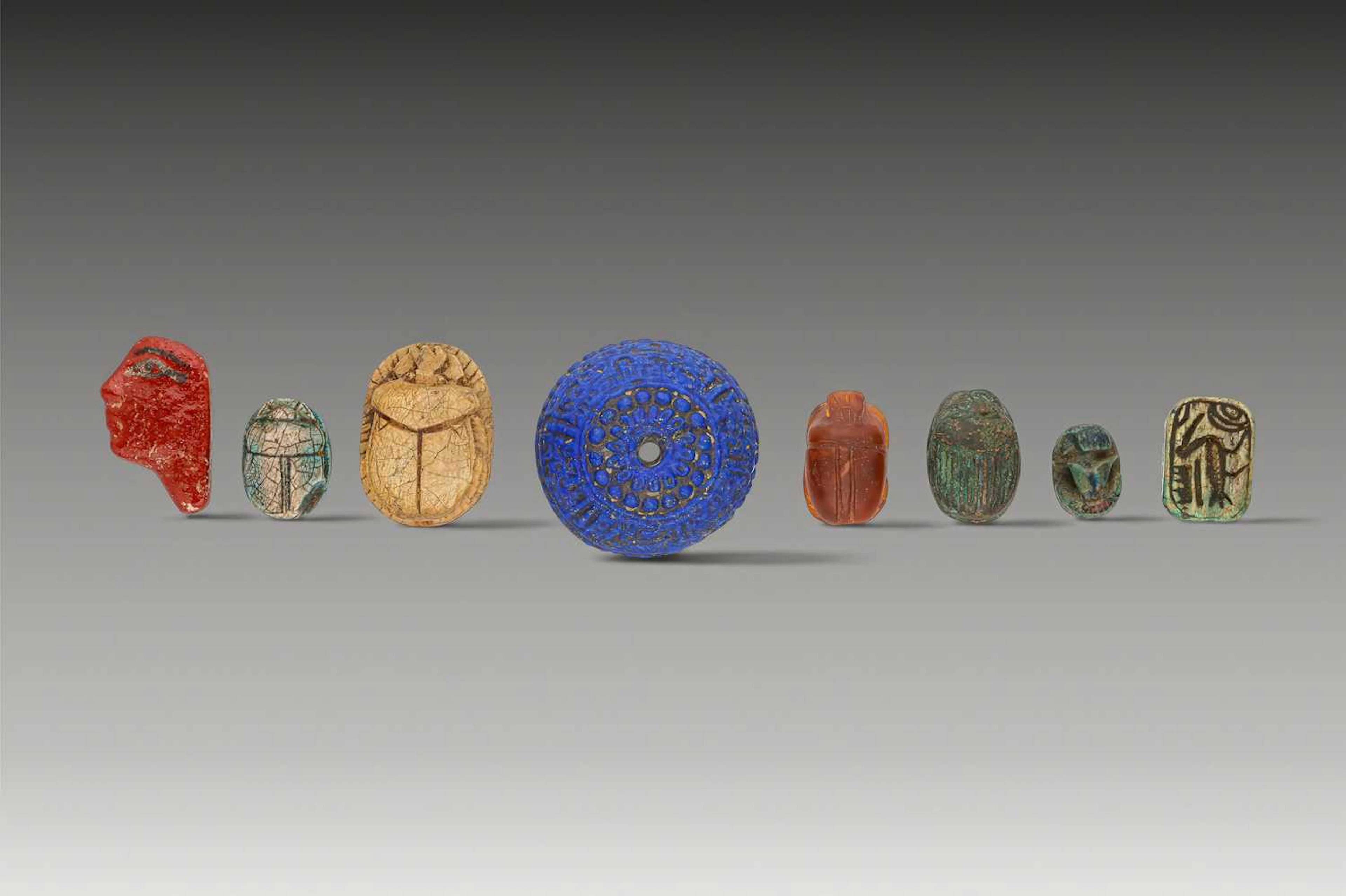 COLLECTION OF EGYPTIAN GLASS, STONE AND FAIENCE AMULETS