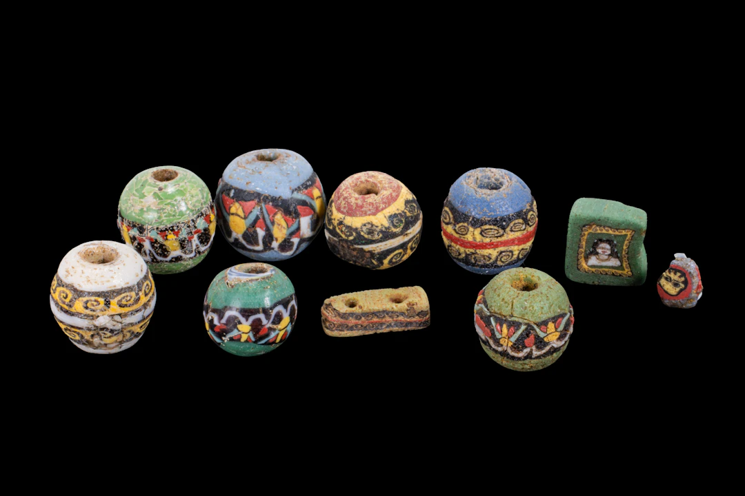 COLLECTION OF ROMAN MOSAIC GLASS BEADS WITH GEOMETRIC AND FIGURAL MOTIFS