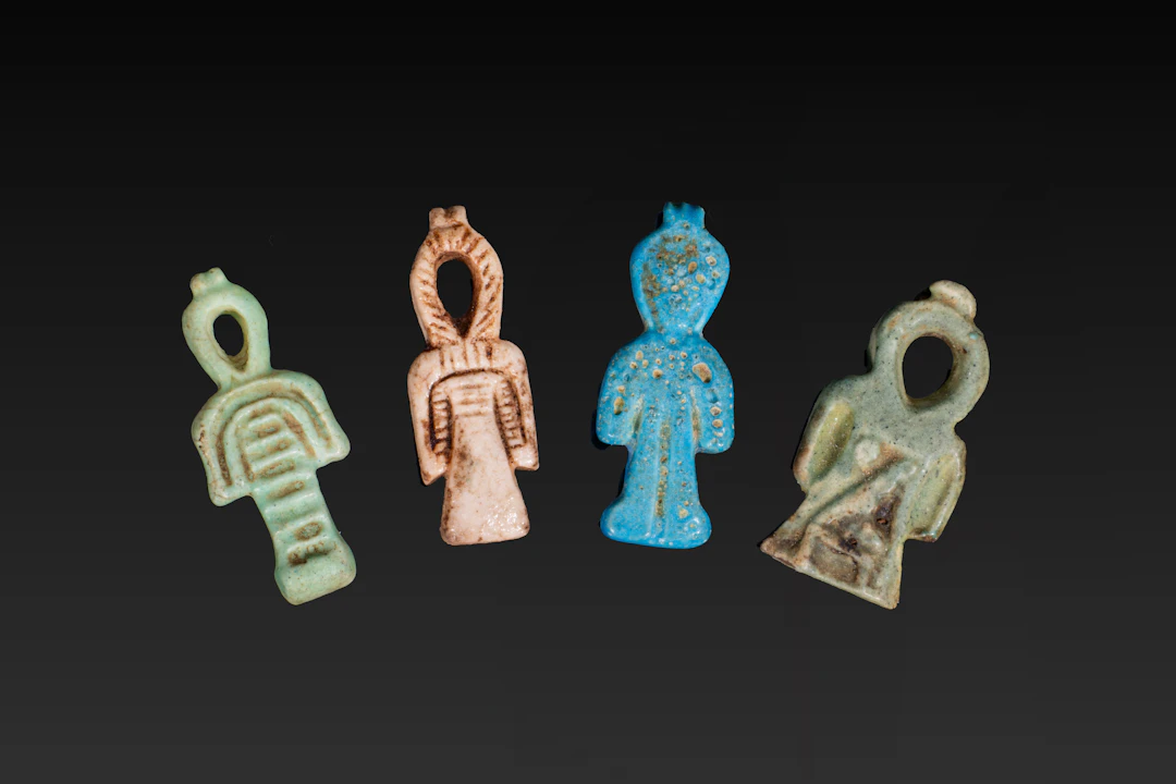 COLLECTION OF EGYPTIAN FAIENCE TYET AMULETS