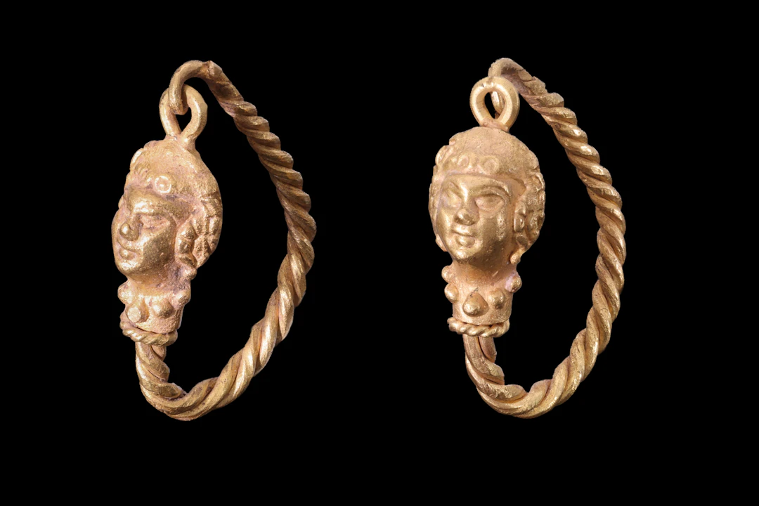 MATCHED PAIR OF HELLENISTIC GOLD EARRINGS WITH LION HEADS