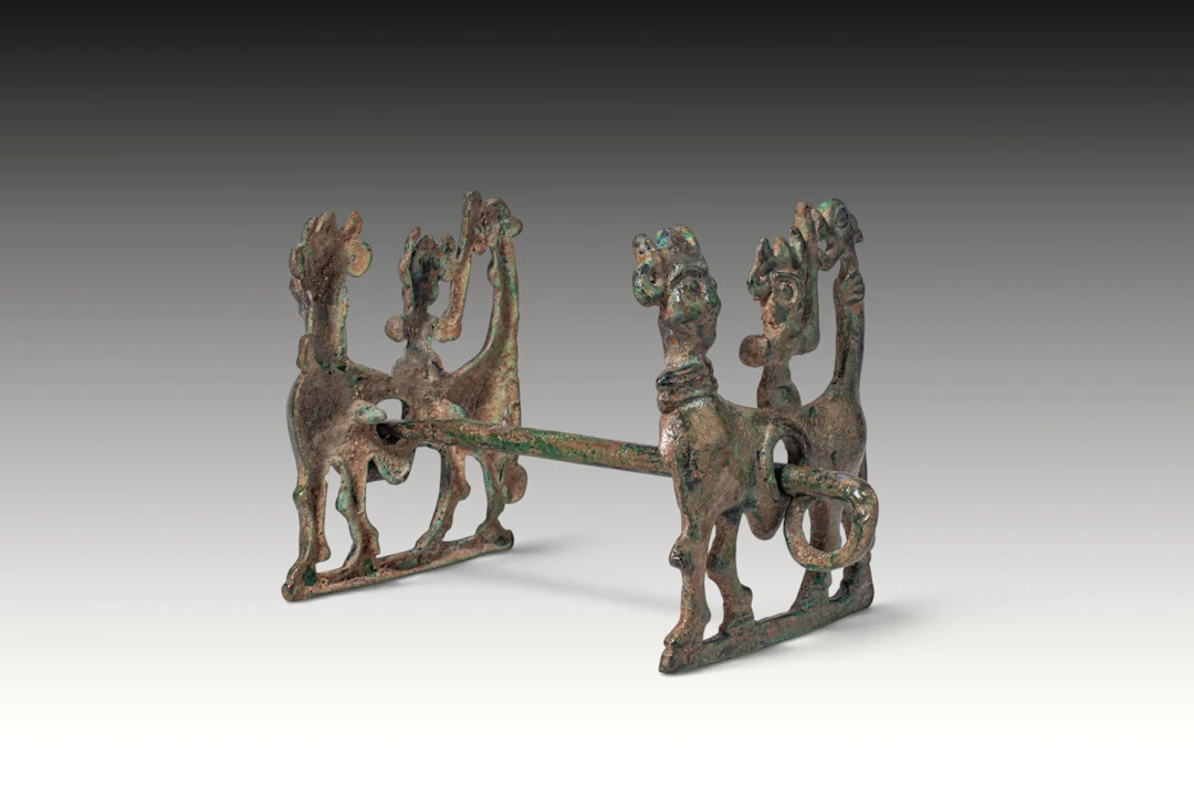 BRONZE AGE BRONZE HORSE BIT WITH FIGURAL CHEEKPIECES