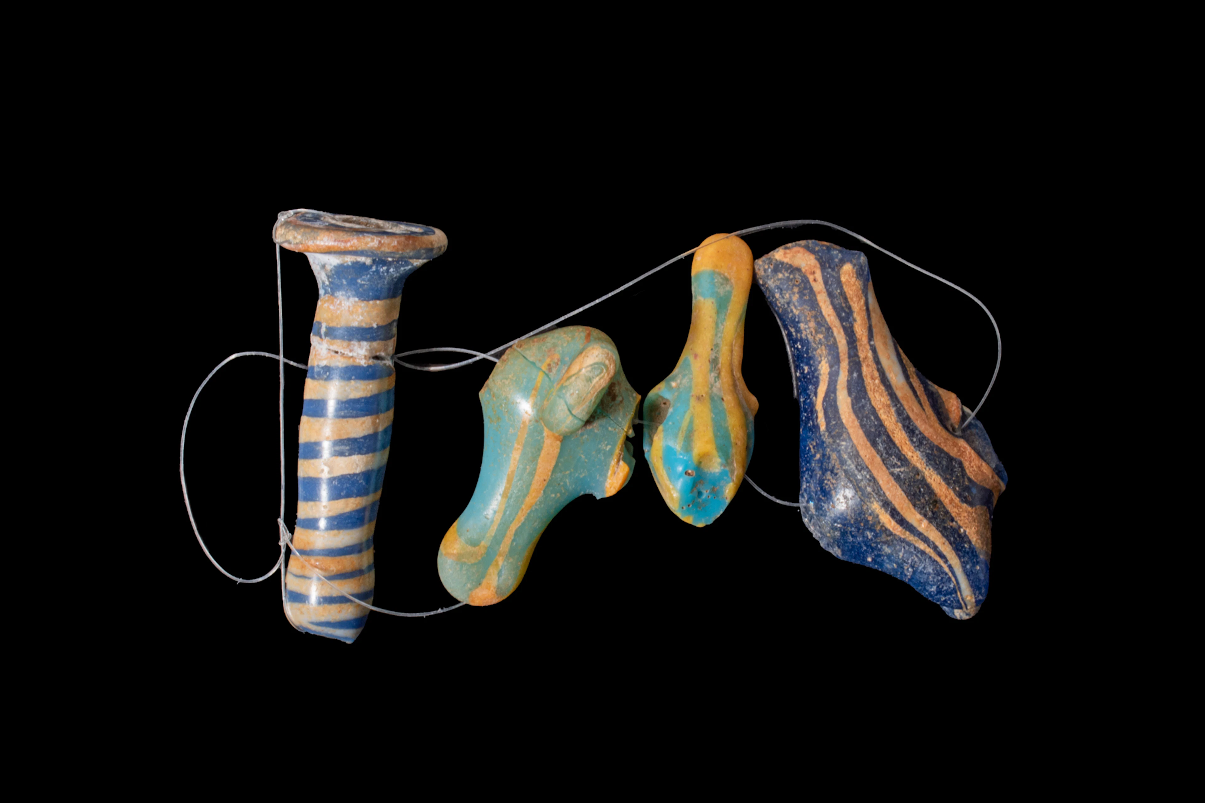 COLLECTION OF EGYPTIAN CORE-FORMED GLASS EAR PLUG AND AMULETS - EX CHRISTIE'S
