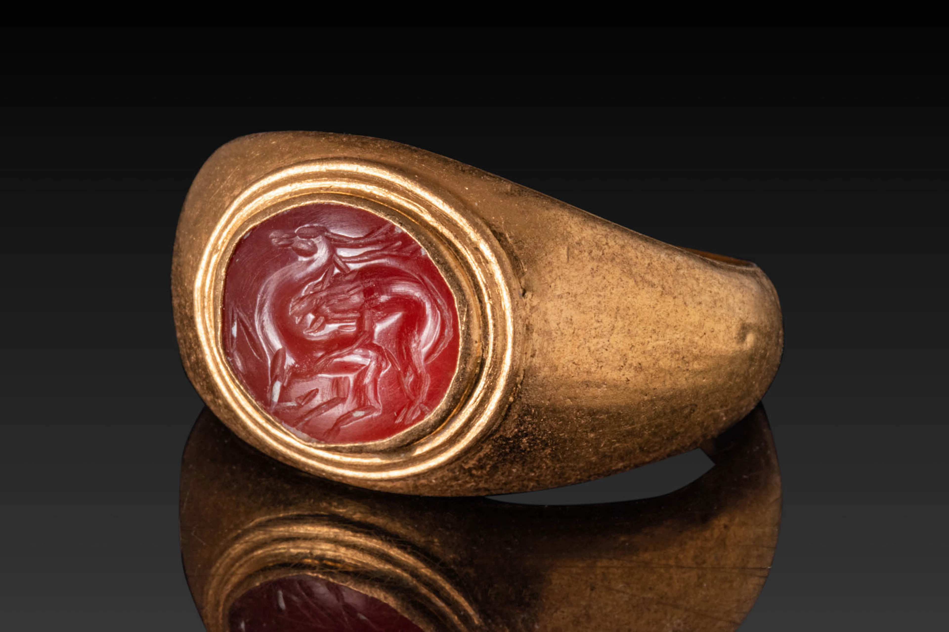 ROMAN INTAGLIO DEPICTING A WOLF ATTACKING A DEER IN HIGH KARAT GOLD RING