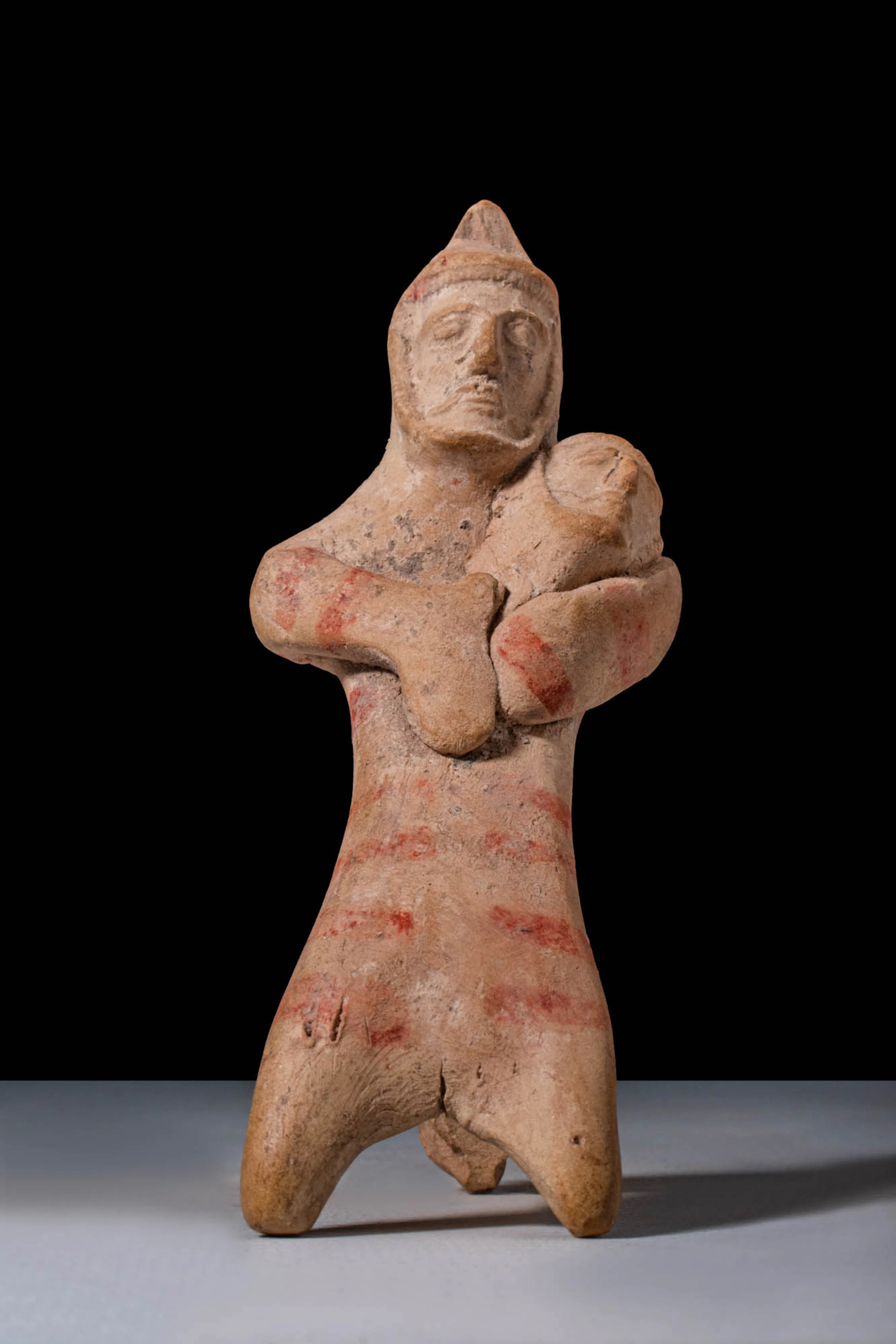 EASTERN GREEK TERRACOTTA FUNERARY TRIPODE FIGURINE DEPICTING A MAN