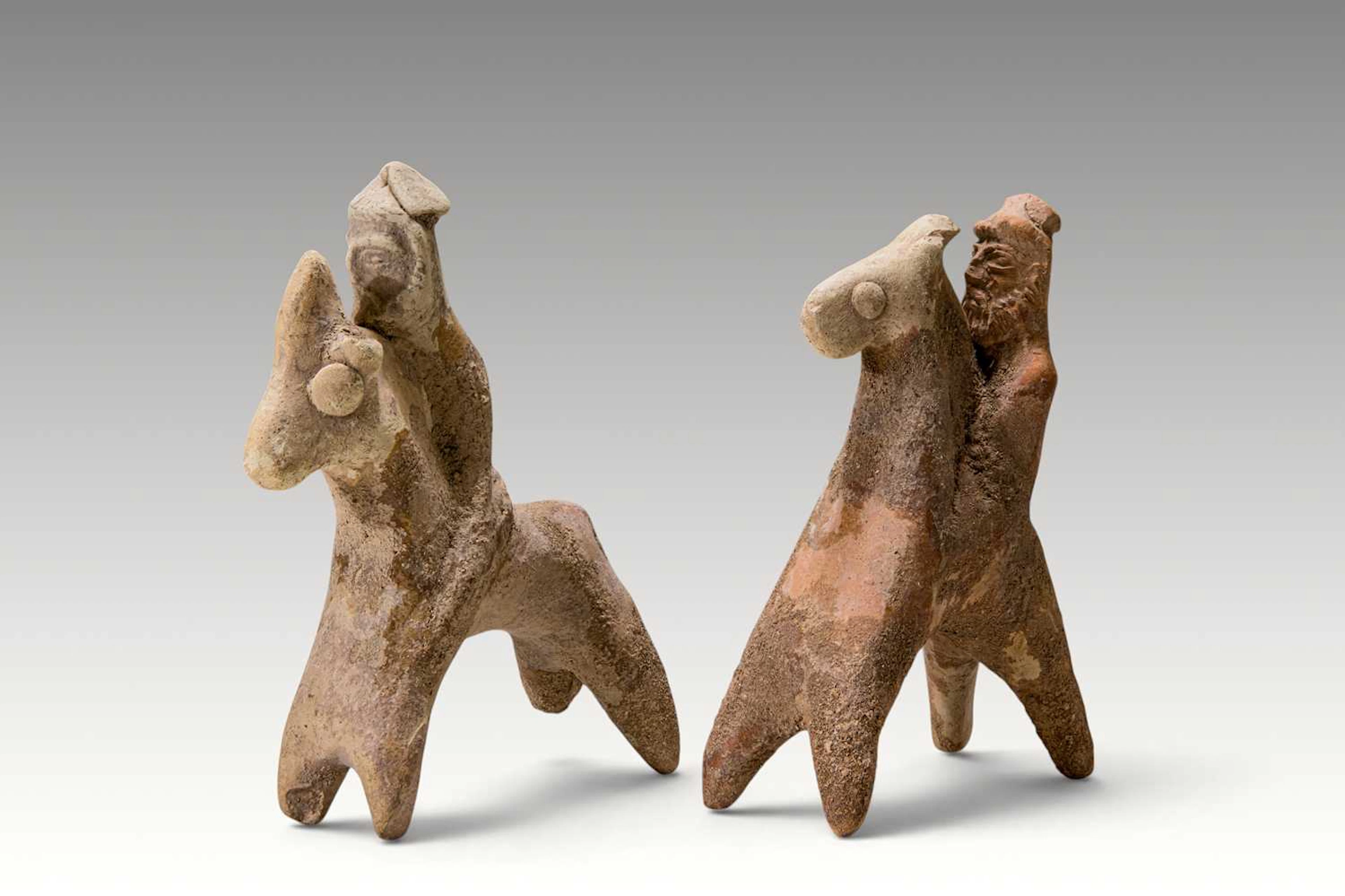 PAIR OF CYPRIOT TERRACOTTA HORSE-AND-RIDER FIGURES