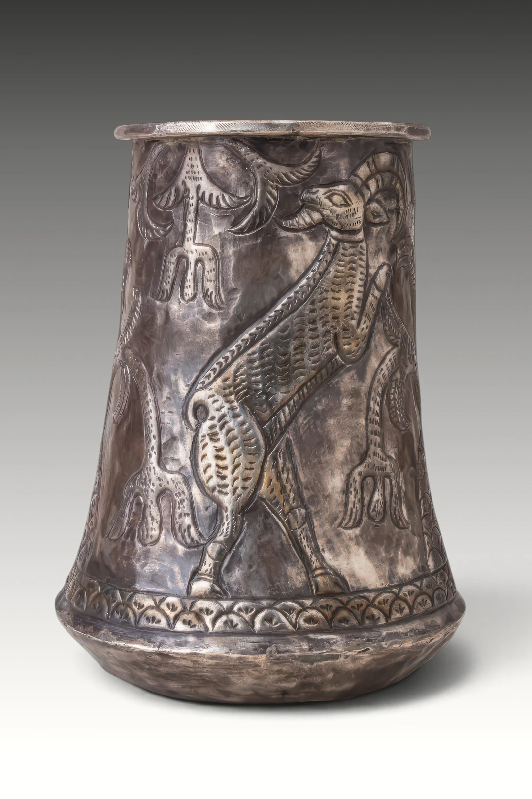 RARE ELAMITE SILVER-GILT BEAKER WITH TREE OF LIFE FLANKED BY RAMPANT STAGS