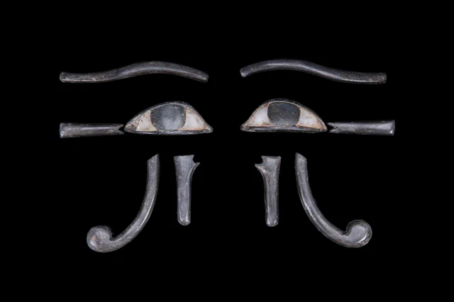 EGYPTIAN PAIR OF COMPOSITE STONE UDJAT-EYE INLAYS