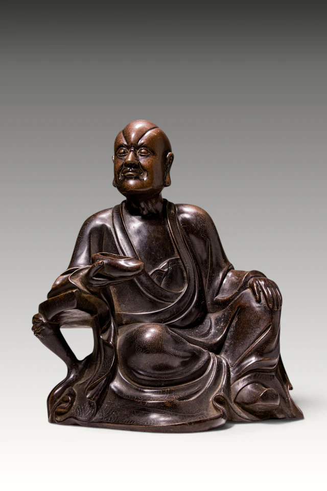 CHINESE SILVER-INLAID BRONZE FIGURE OF A LUOHAN
