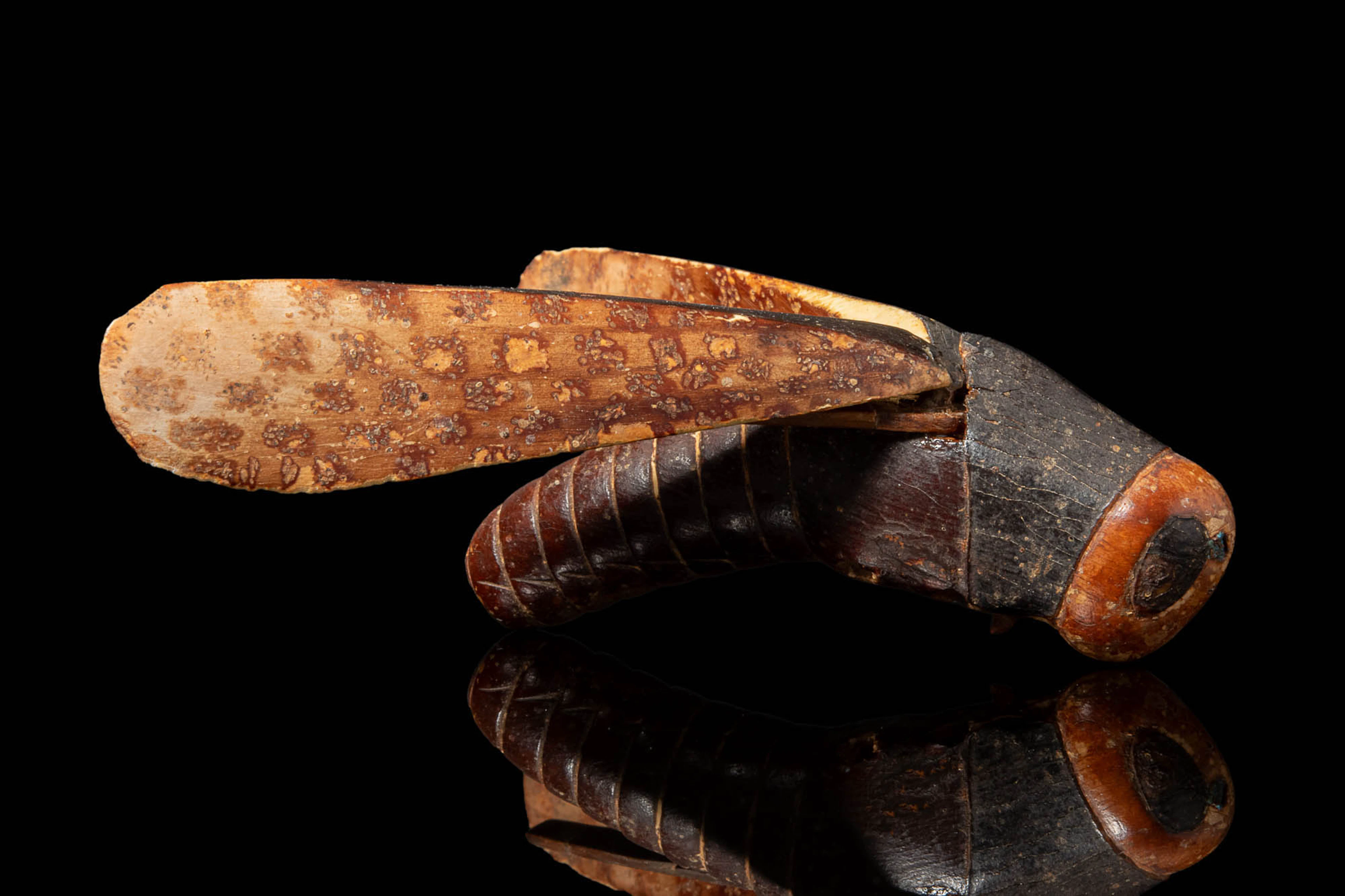 EGYPTIAN IVORY AND WOOD COSMETIC VESSEL IN THE FORM OF A GRASSHOPPER