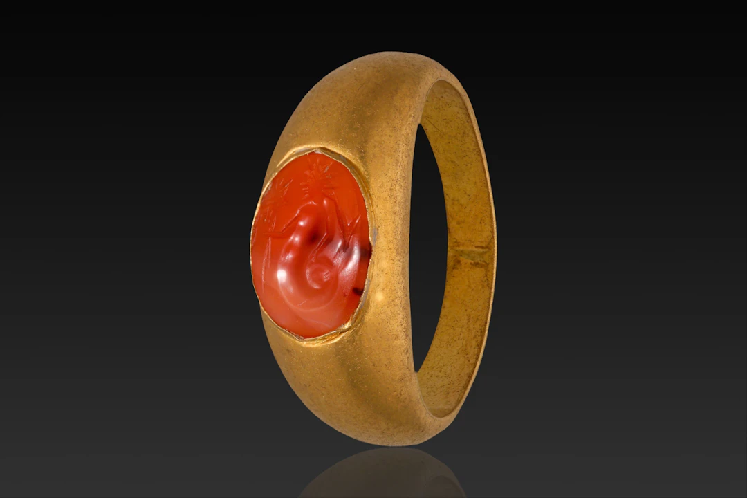 ROMAN CARNELIAN INTAGLIO OF TRITON IN GOLD RING