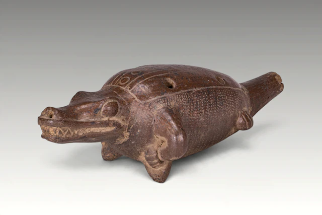 PRE-COLUMBIAN ZOOMORPHIC POTTERY WHISTLE IN THE FORM OF A CROCODILE