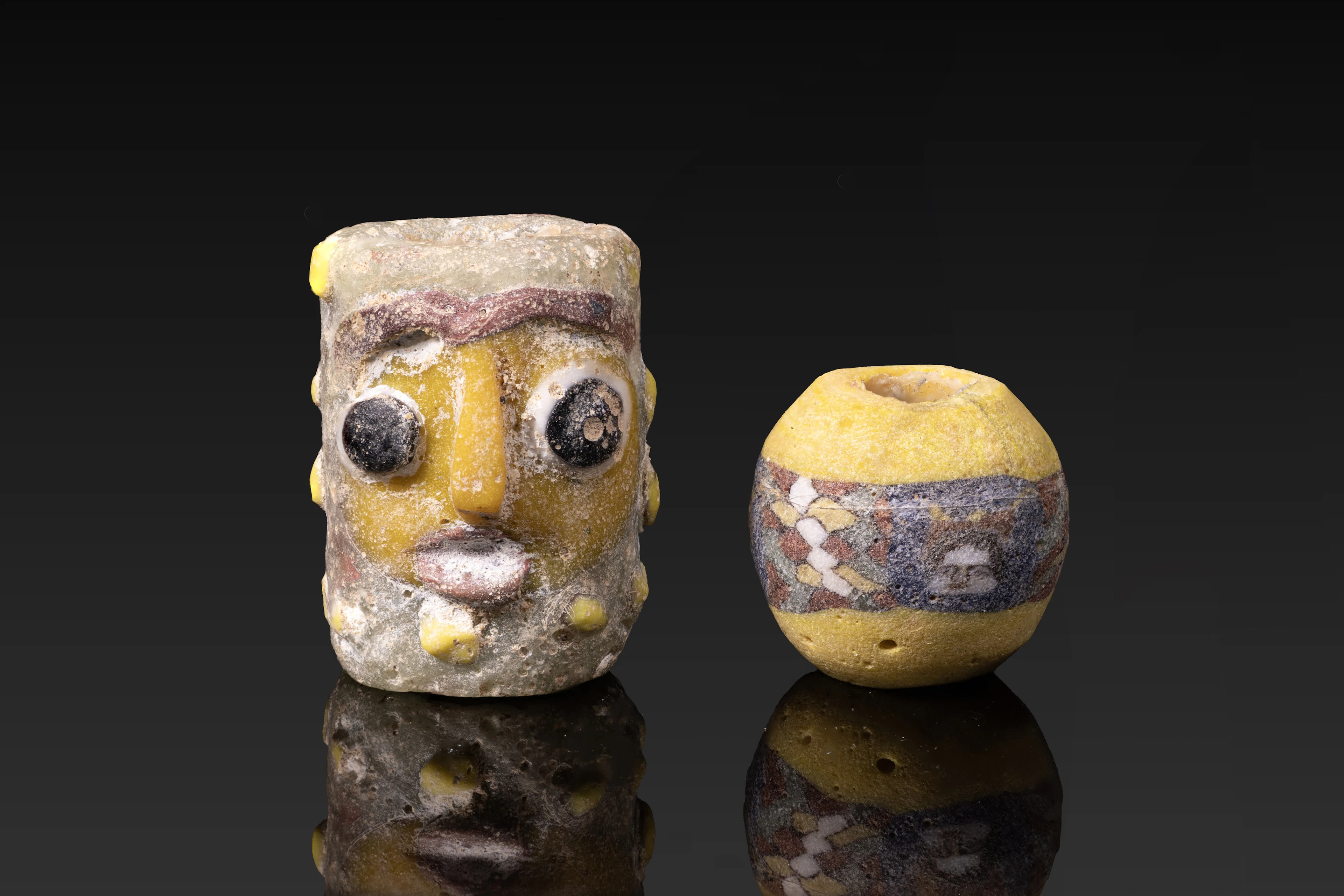 PAIR OF CARTHAGINIAN AND ROMAN GLASS BEADS