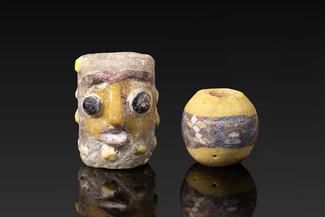 PAIR OF CARTHAGINIAN AND ROMAN GLASS BEADS