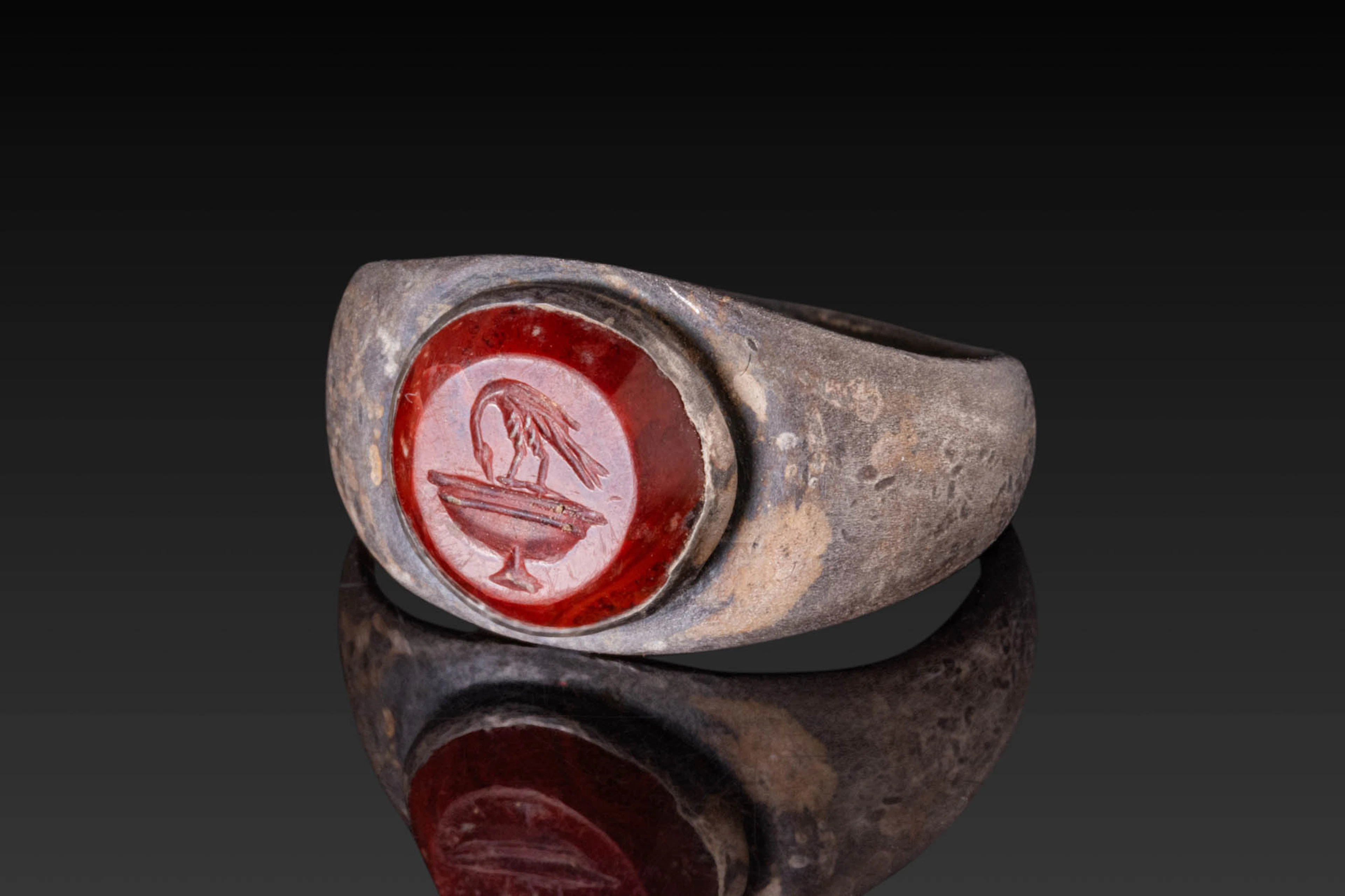 ROMAN RED JASPER INTAGLIO DEPICTING A BIRD ON A LABRUM IN SILVER RING