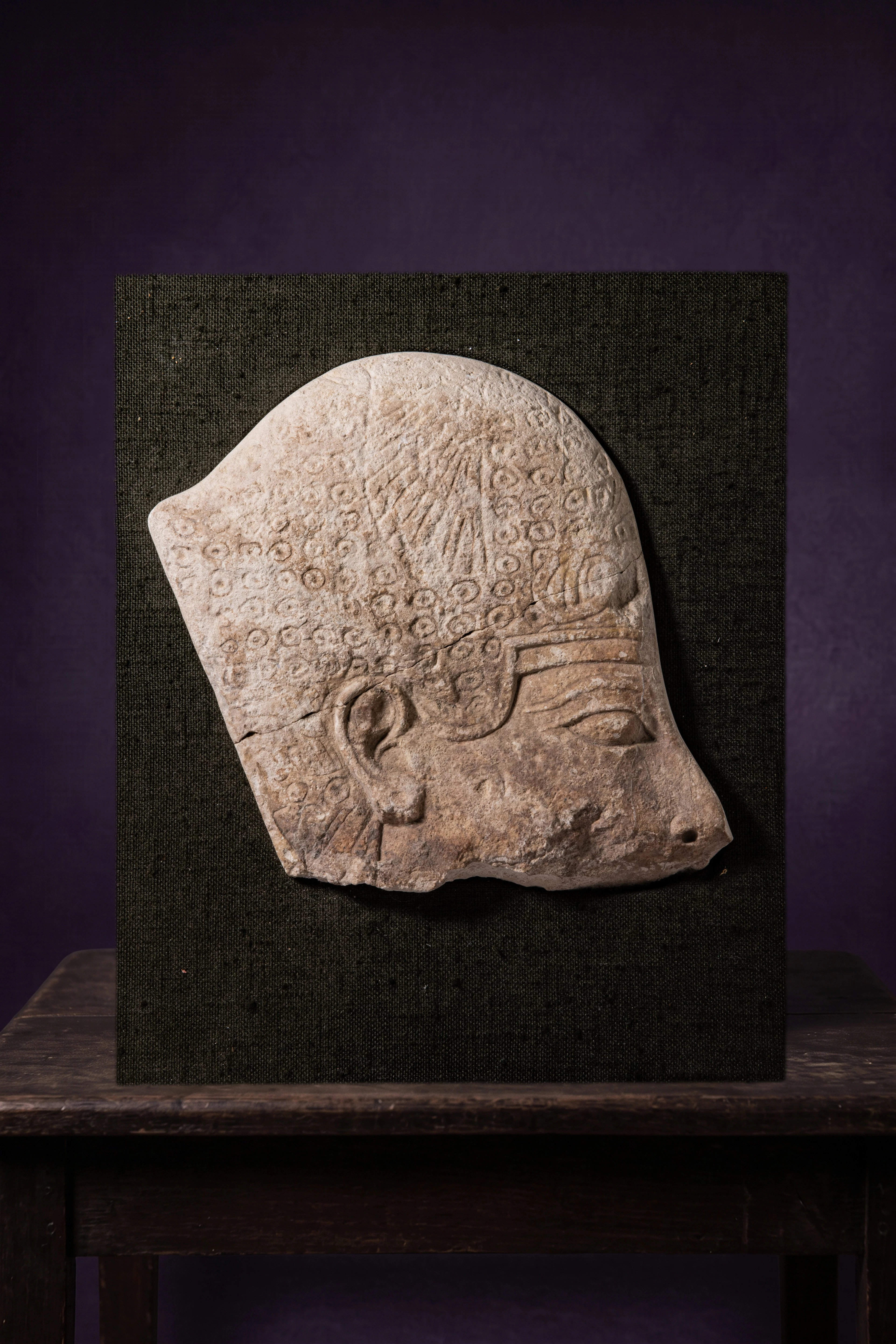EGYPTIAN RELIEF WITH THE HEAD OF A KING WEARING THE KHEPRESH CROWN