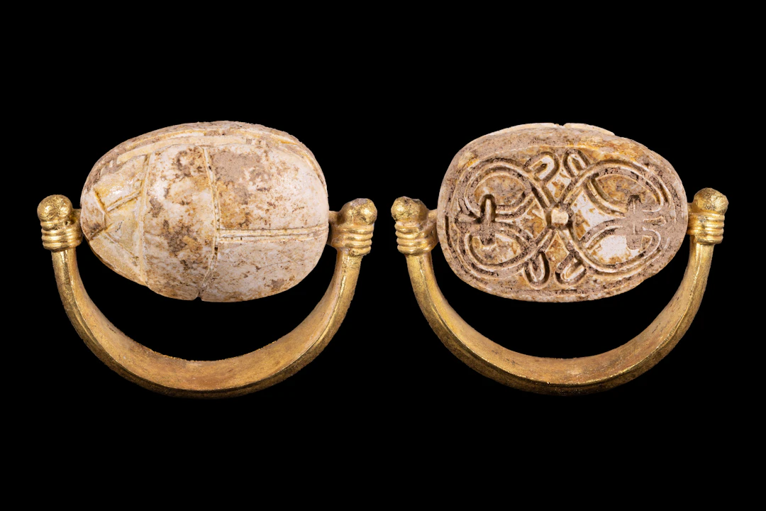 EGYPTIAN GOLD SWIVEL RING WITH STEATITE SCARAB ENGRAVED WITH FLORAL MOTIF