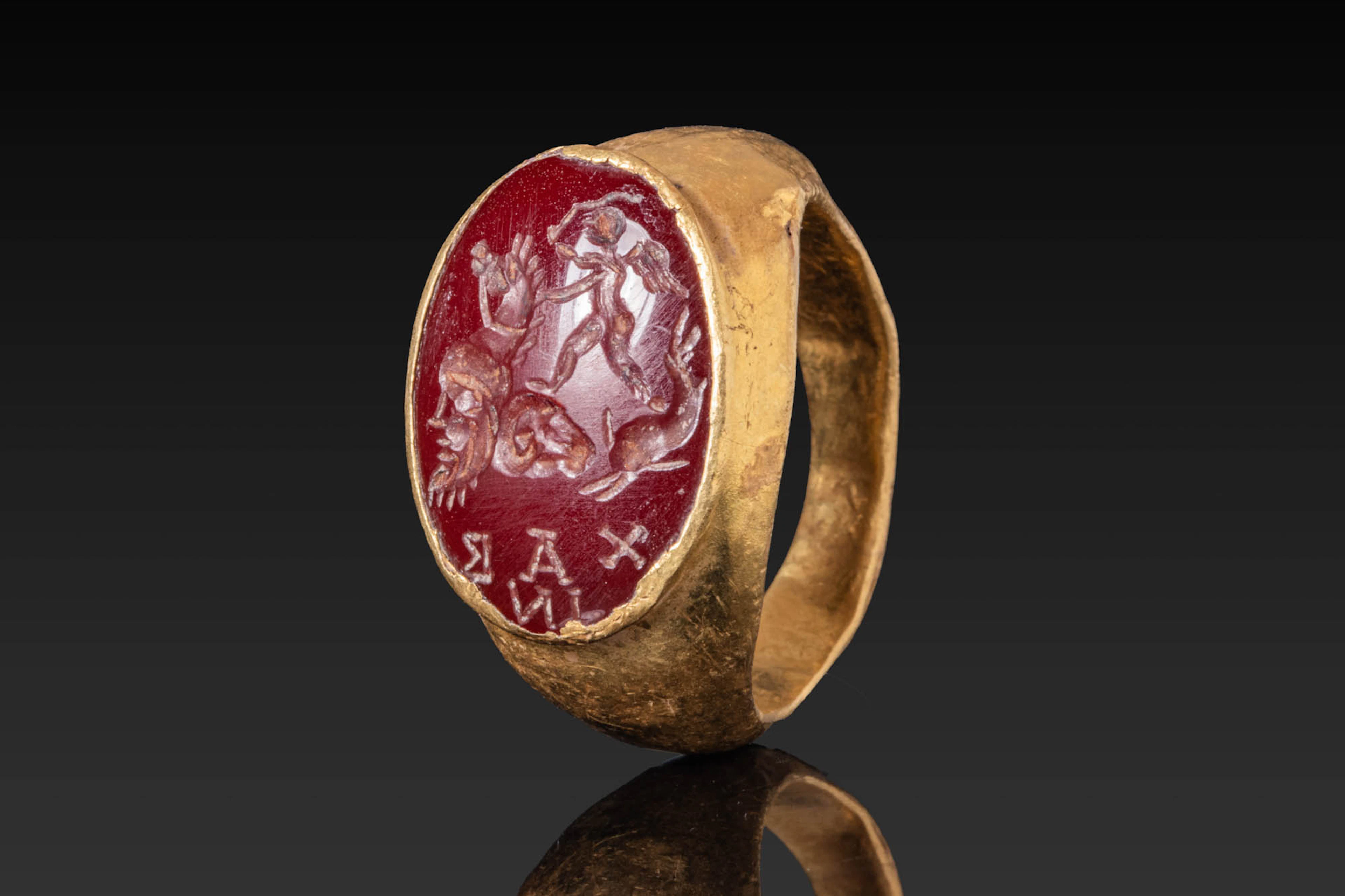 LARGE ROMAN RED GARNET INTAGLIO DEPICTING CUPID AND GRYLLOS IN HIGH