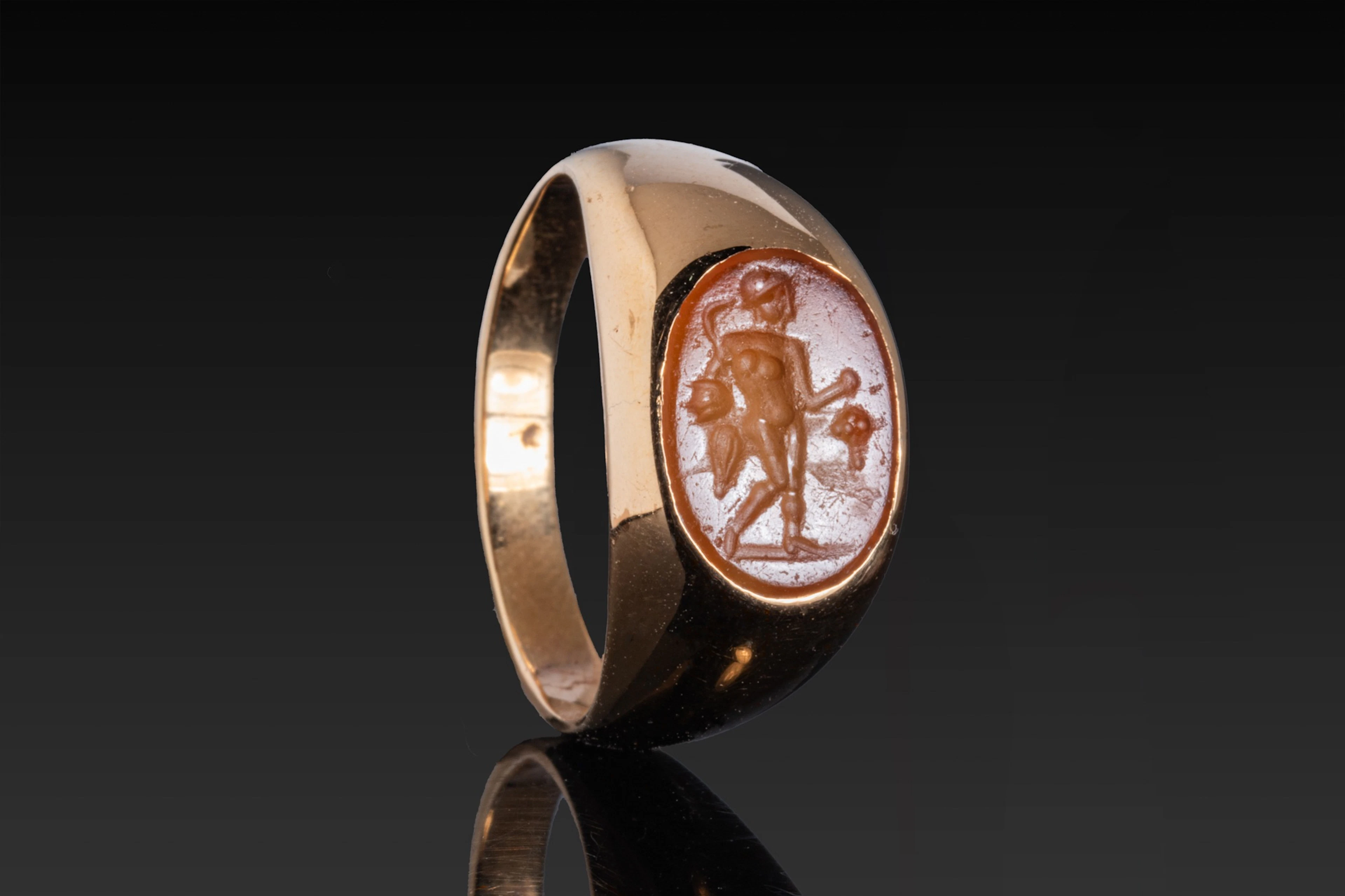 HELLENISTIC CARNELIAN INTAGLIO OF APOLLO IN HIGH KARAT GOLD RING