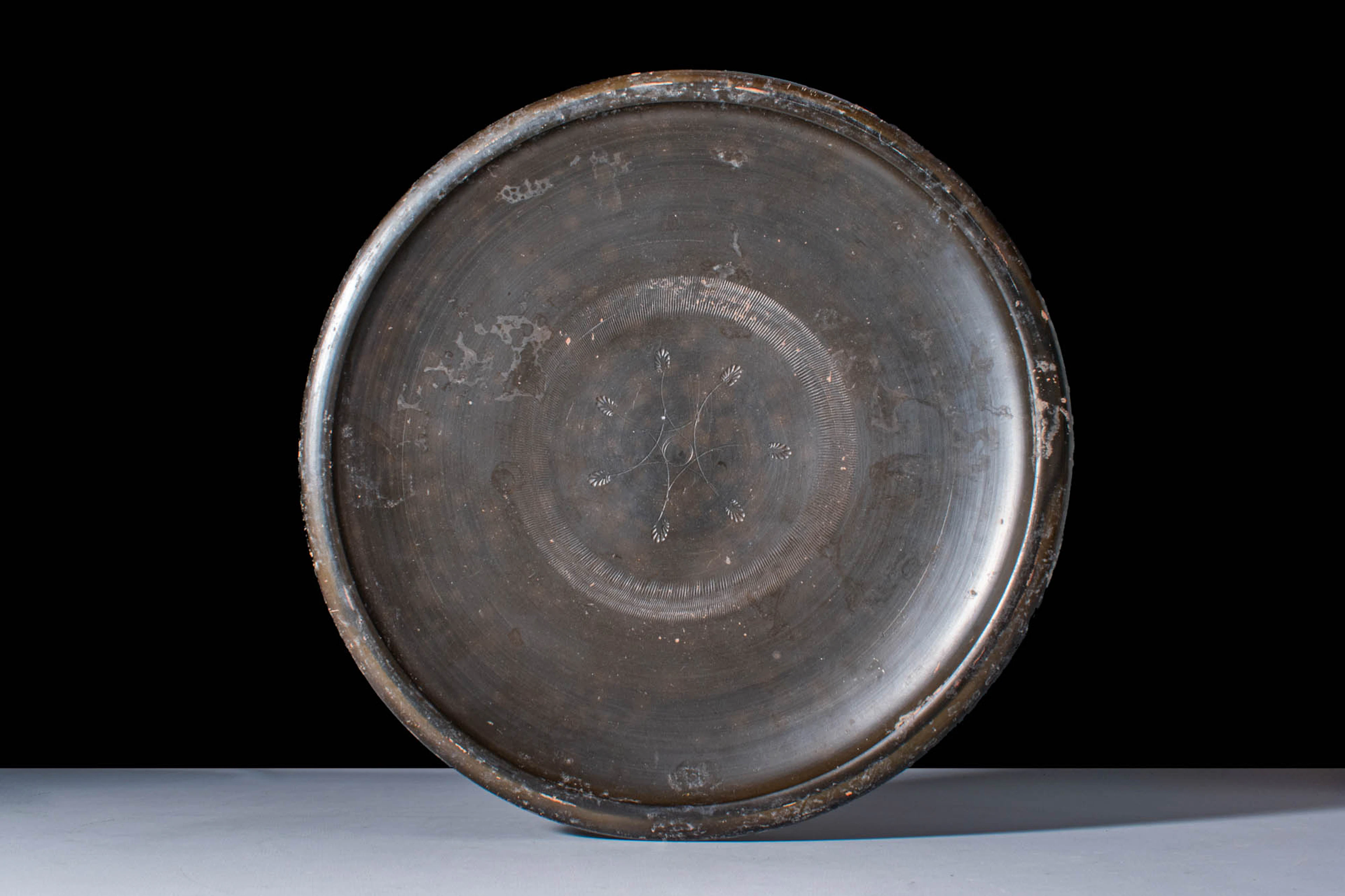 GREEK BLACK GLAZE PLATE WITH STAMPED PALMETTES