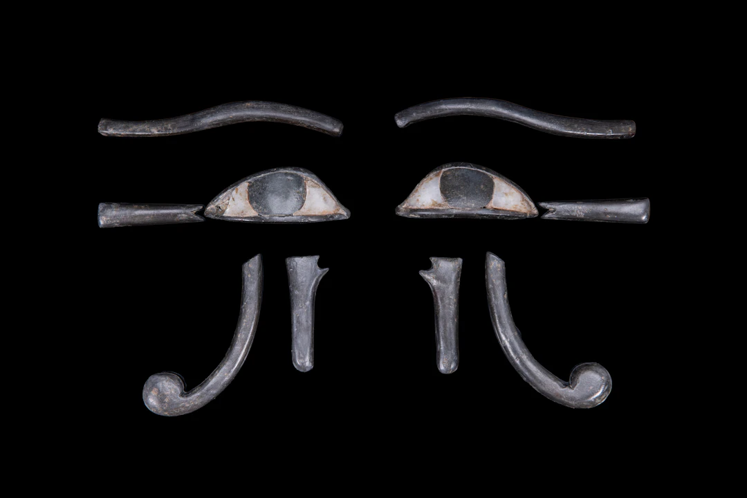 EGYPTIAN PAIR OF COMPOSITE STONE UDJAT-EYE INLAYS