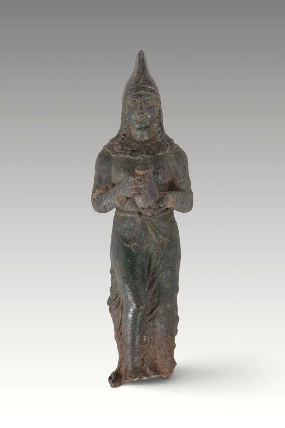 EASTERN MEDITERRANEAN BRONZE FIGURE OF A FEMALE OFFERER