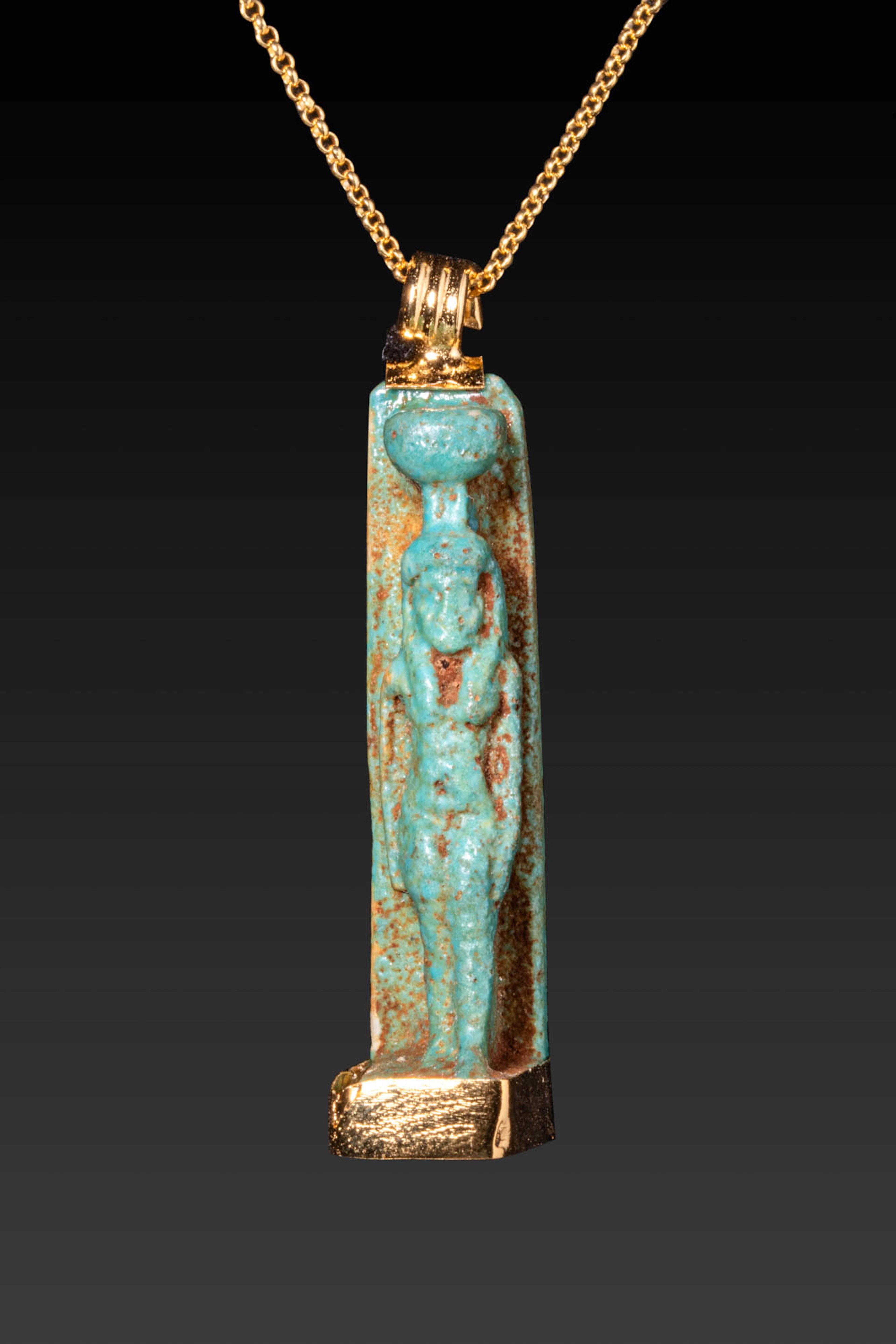 EGYPTIAN FAIENCE AMULET DEPICTING ISIS SET IN AN 18K SILVER-GILT PENDANT