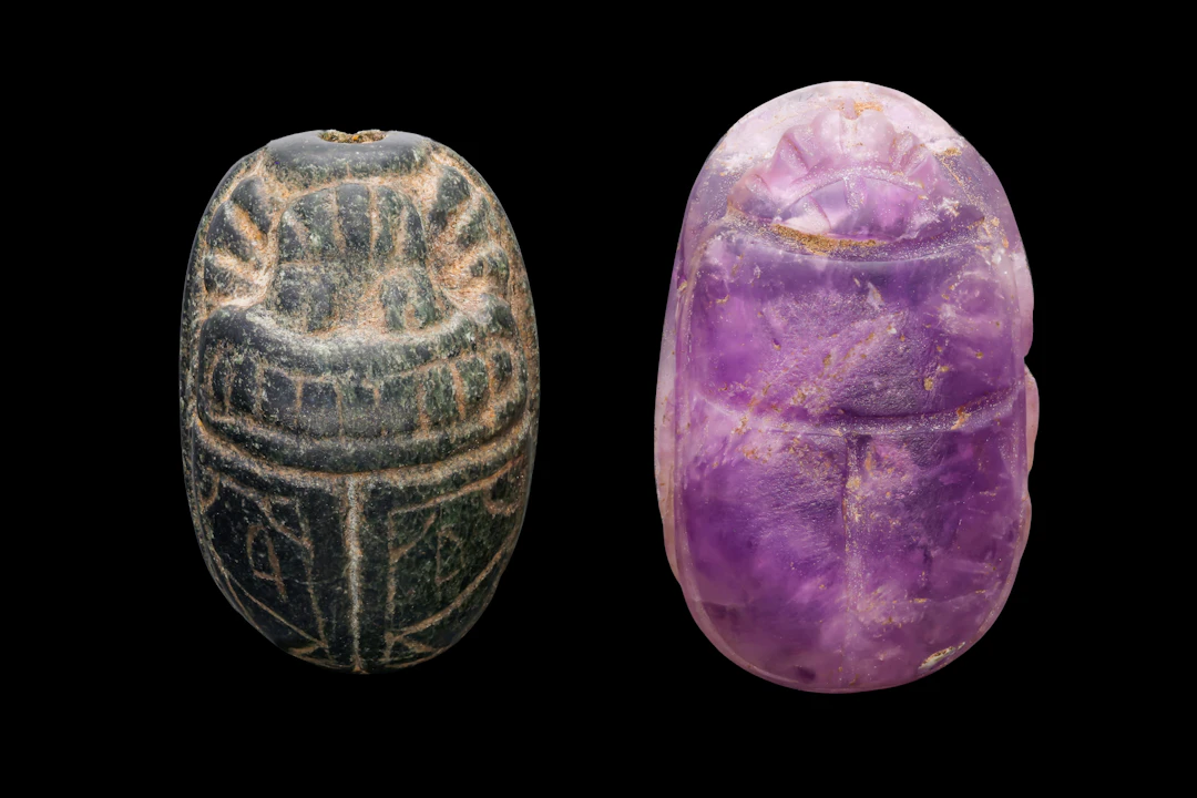 PAIR OF EGYPTIAN GREEN STONE AND AMETHYST SCARABS