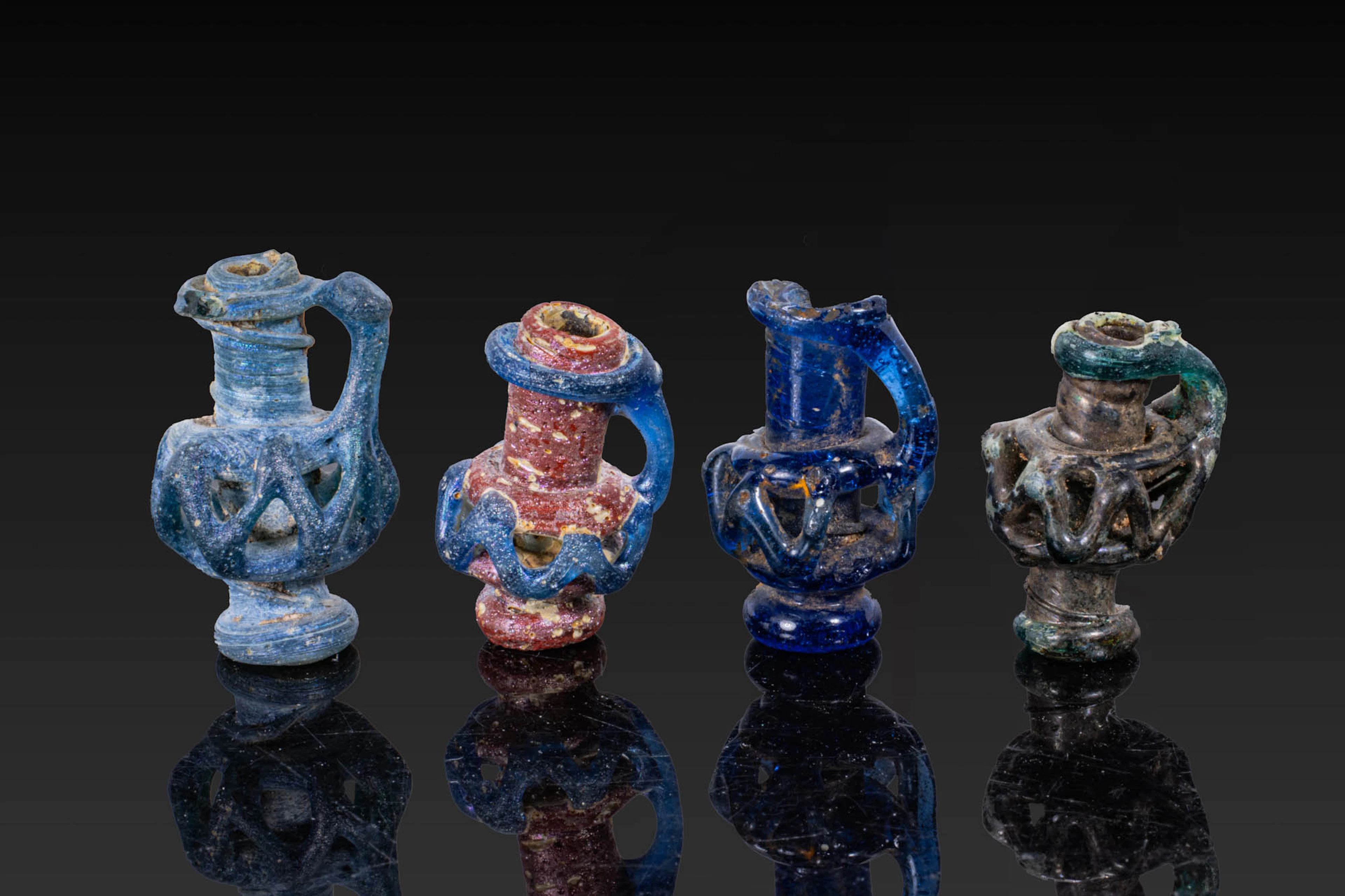 COLLECTION OF LATE ROMAN GLASS MINIATURE JUG-SHAPED PENDANTS
