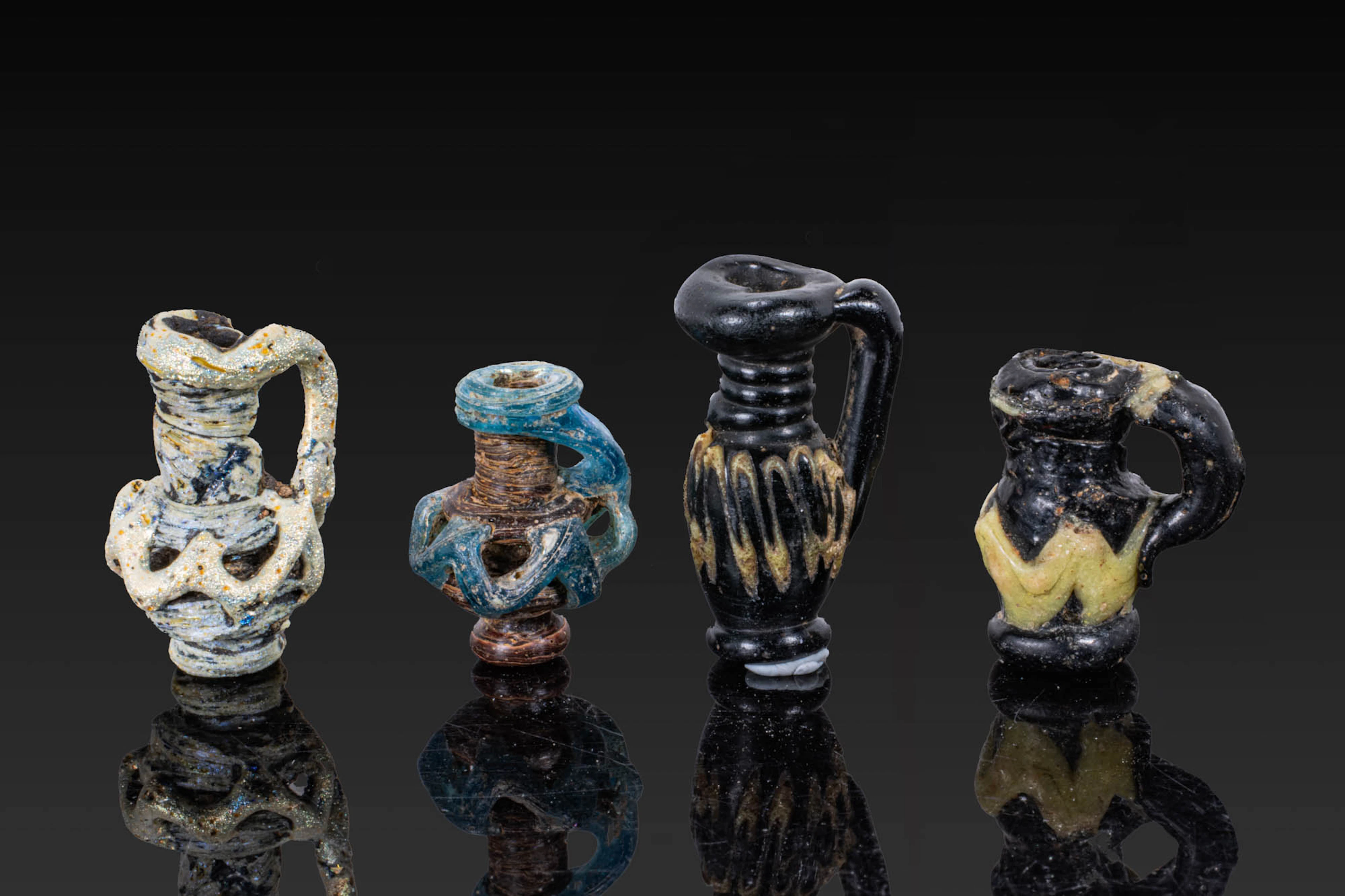 COLLECTION OF LATE ROMAN GLASS MINIATURE JUG-SHAPED PENDANTS