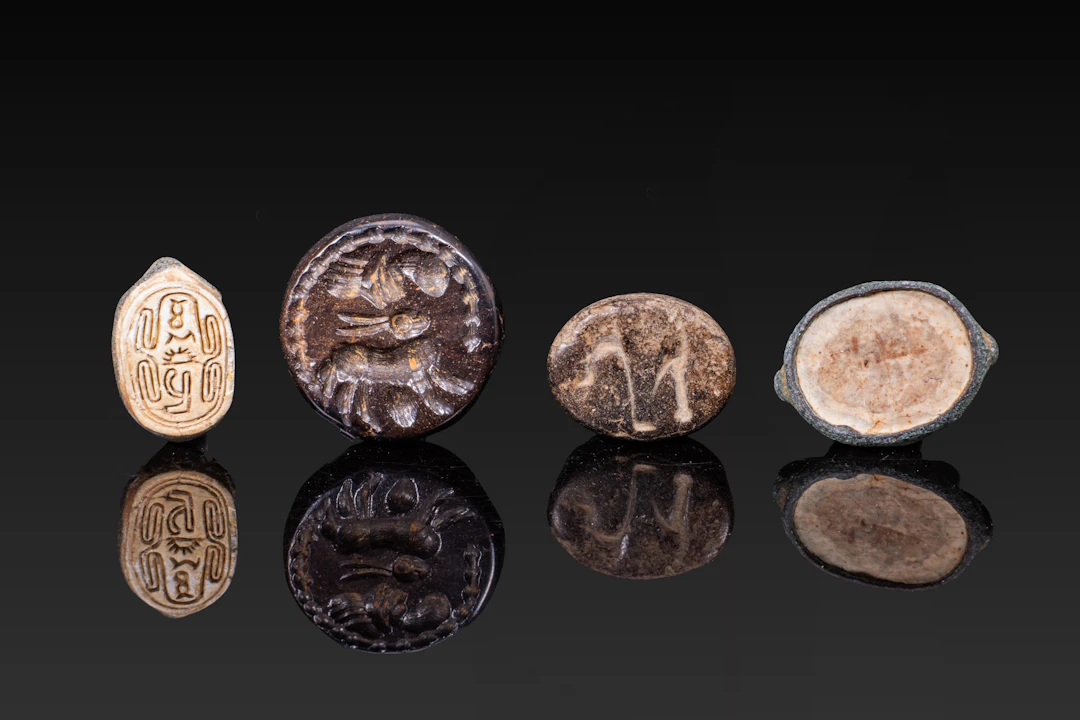 COLLECTION OF EGYPTIAN STONE AND BRONZE SCARABS AND AMULET SEALS