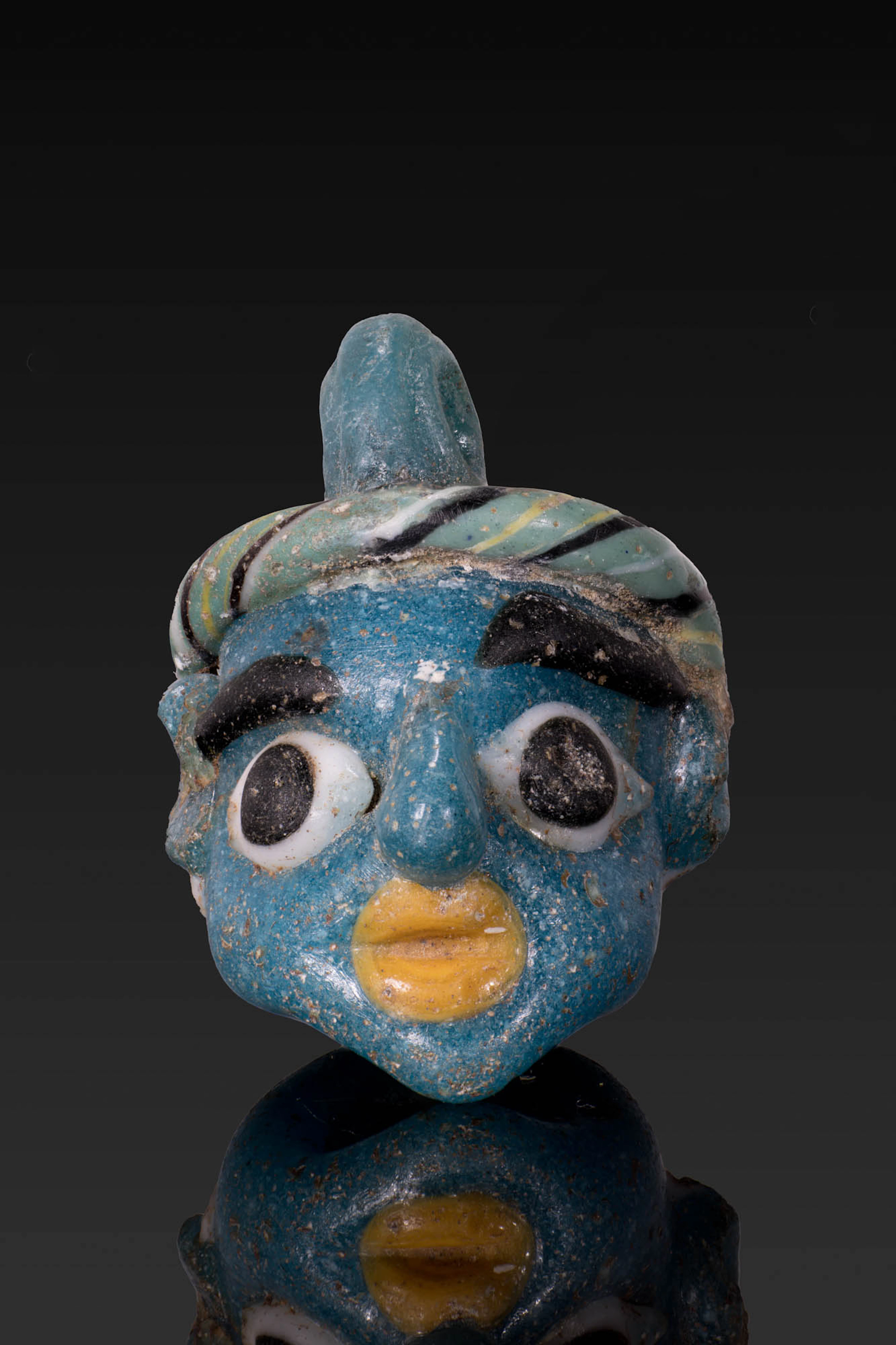 GRAECO-PHOENICIAN POLYCHROME GLASS FACE BEAD