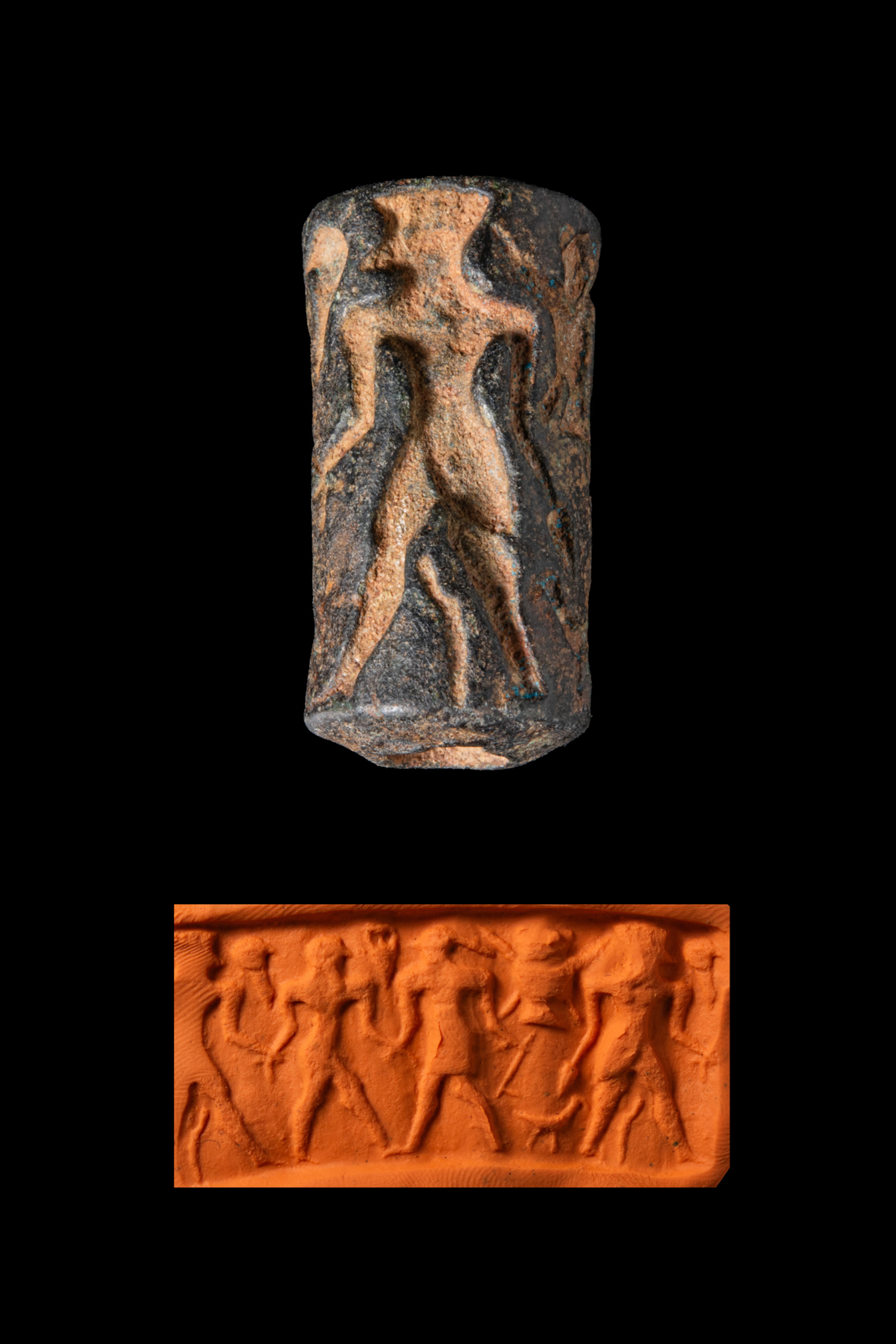 ELAMITE BLACK STONE CYLINDER SEAL WITH STANDING FIGURE AND PRISONER