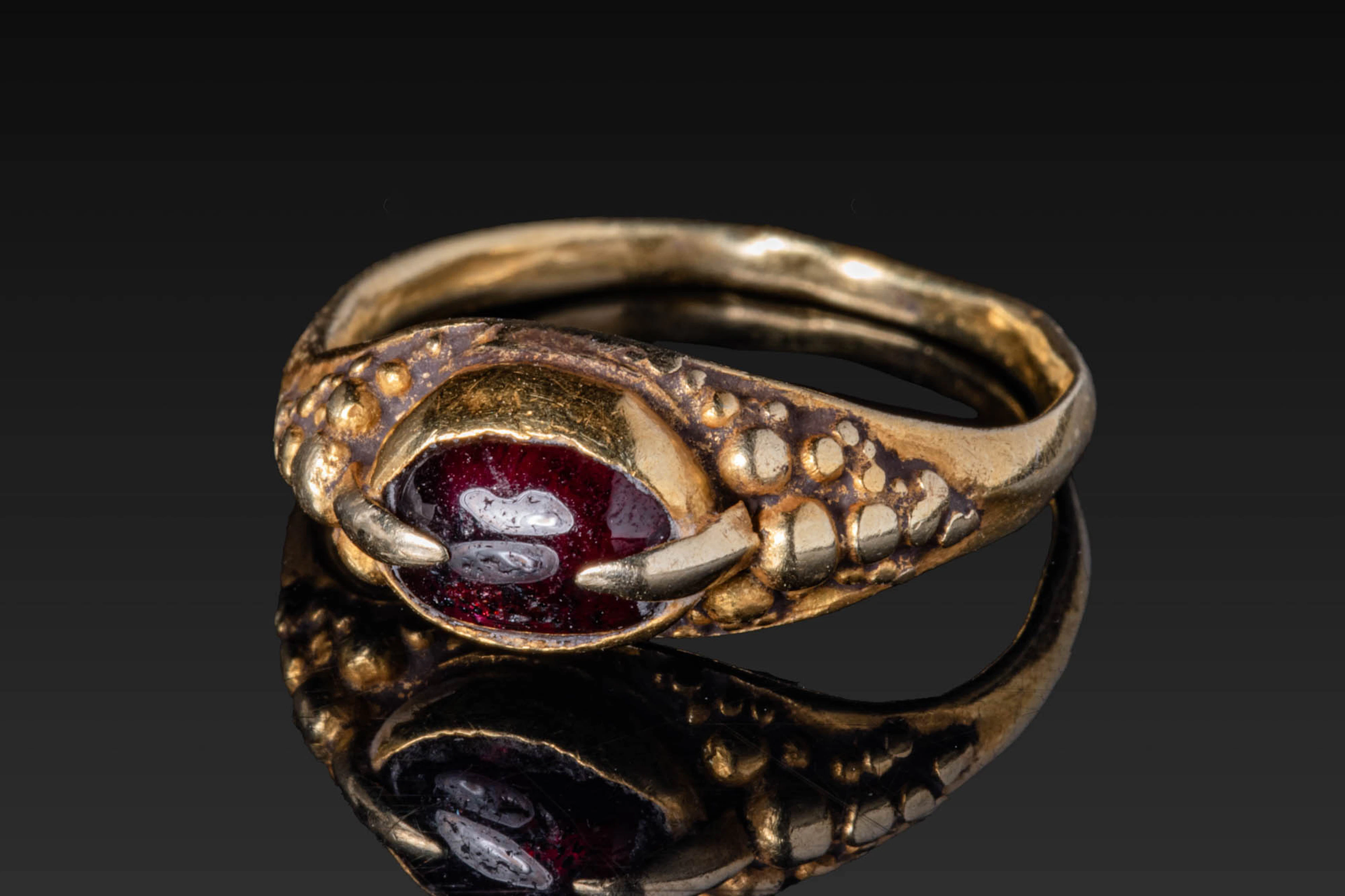 MEDIEVAL HIGH KARAT GOLD RING WITH RED GARNET CABOCHON