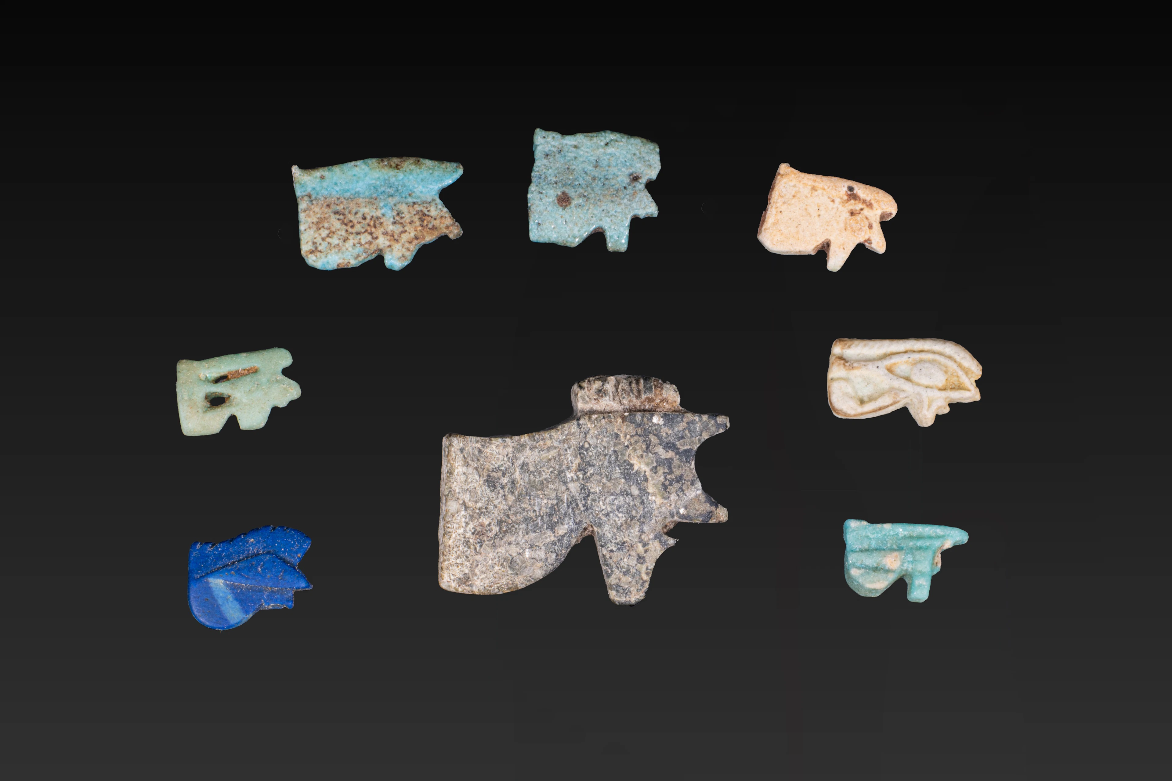 COLLECTION OF FAIENCE AND STONE WADJET AMULETS