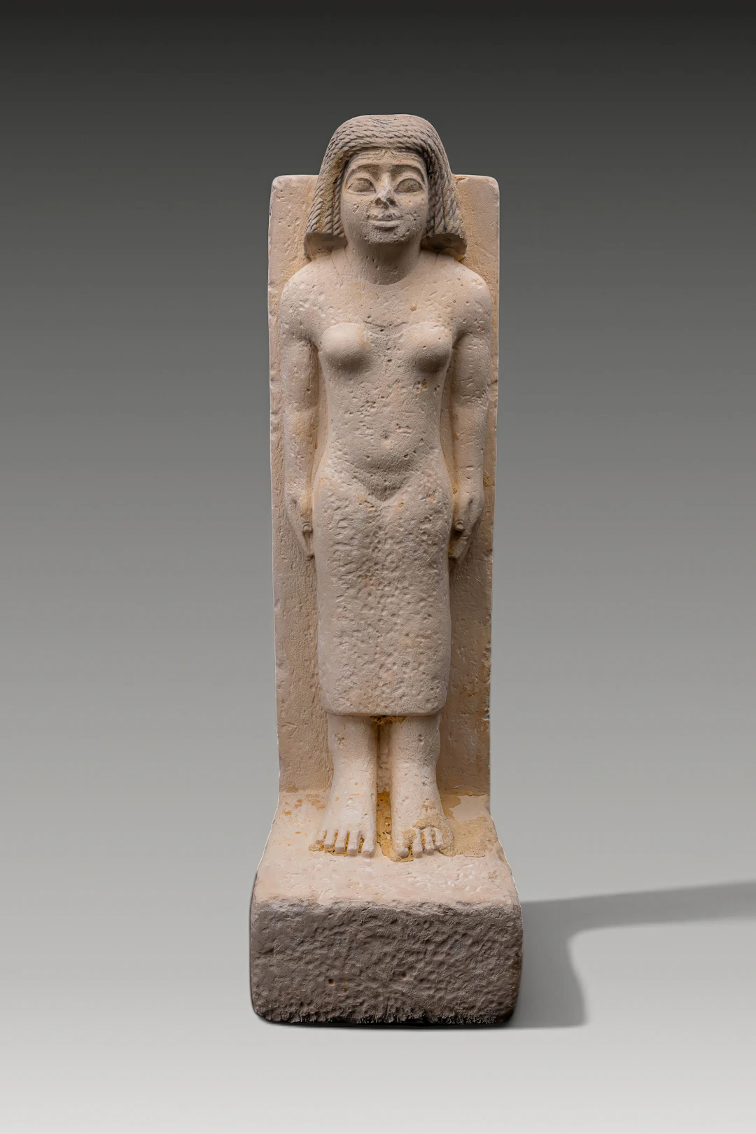 EGYPTIAN SANDSTONE STATUE OF A STANDING WOMAN
