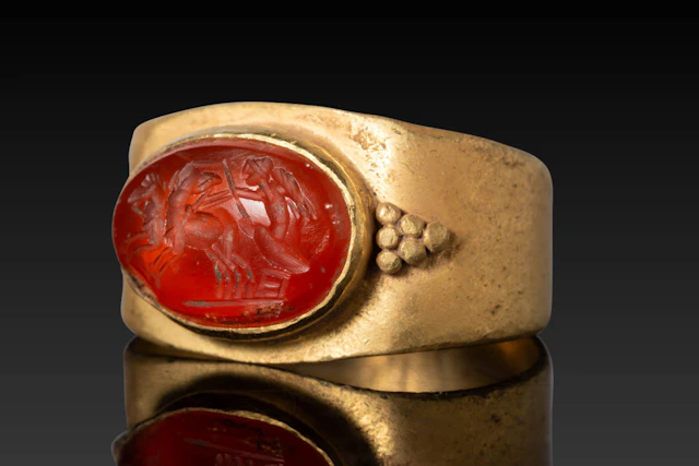 ROMAN CARNELIAN INTAGLIO DEPICTING CUPID DRIVING A TWO-HORSE CHARIOT