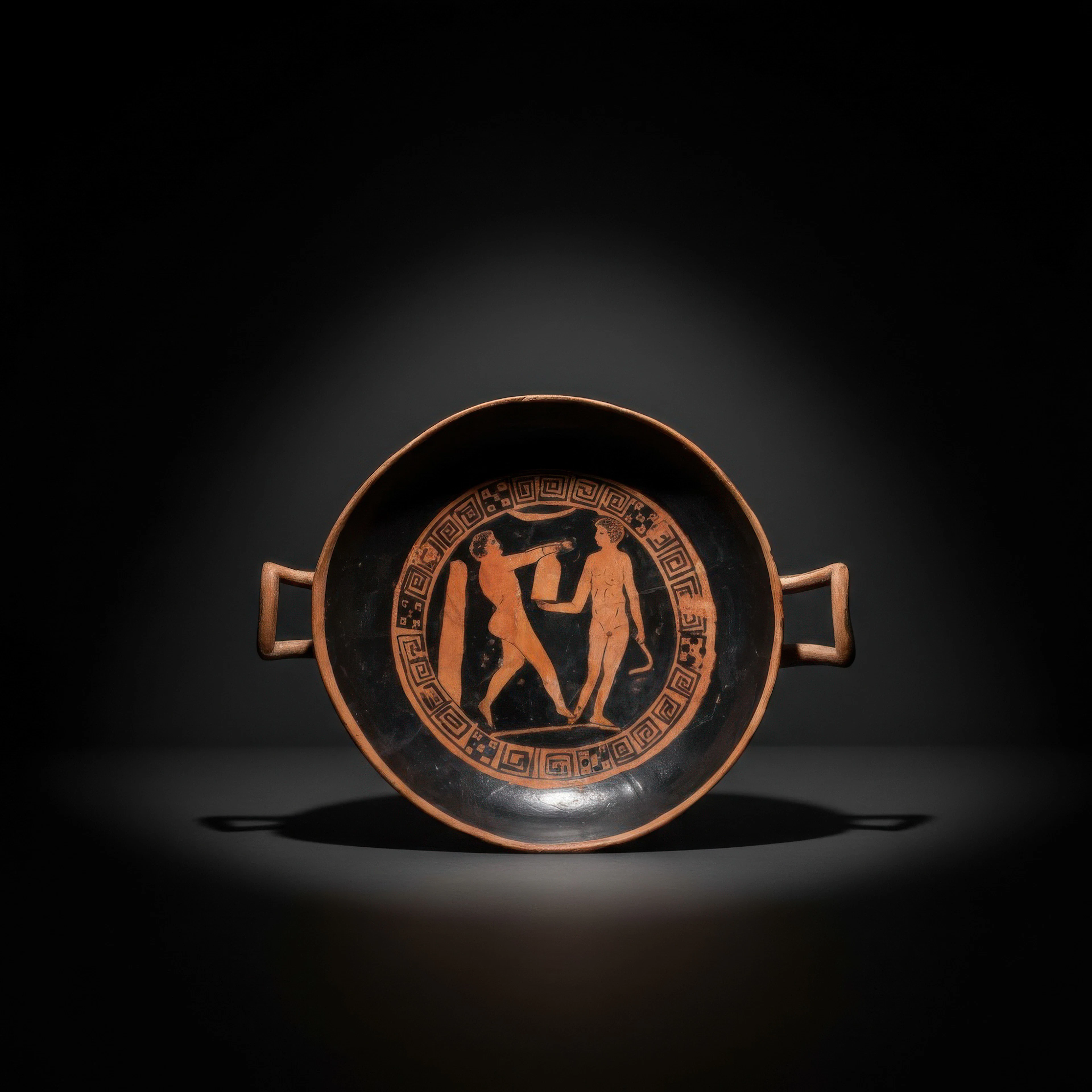 GREEK RED-FIGURE KYLIX WITH ATHLETES